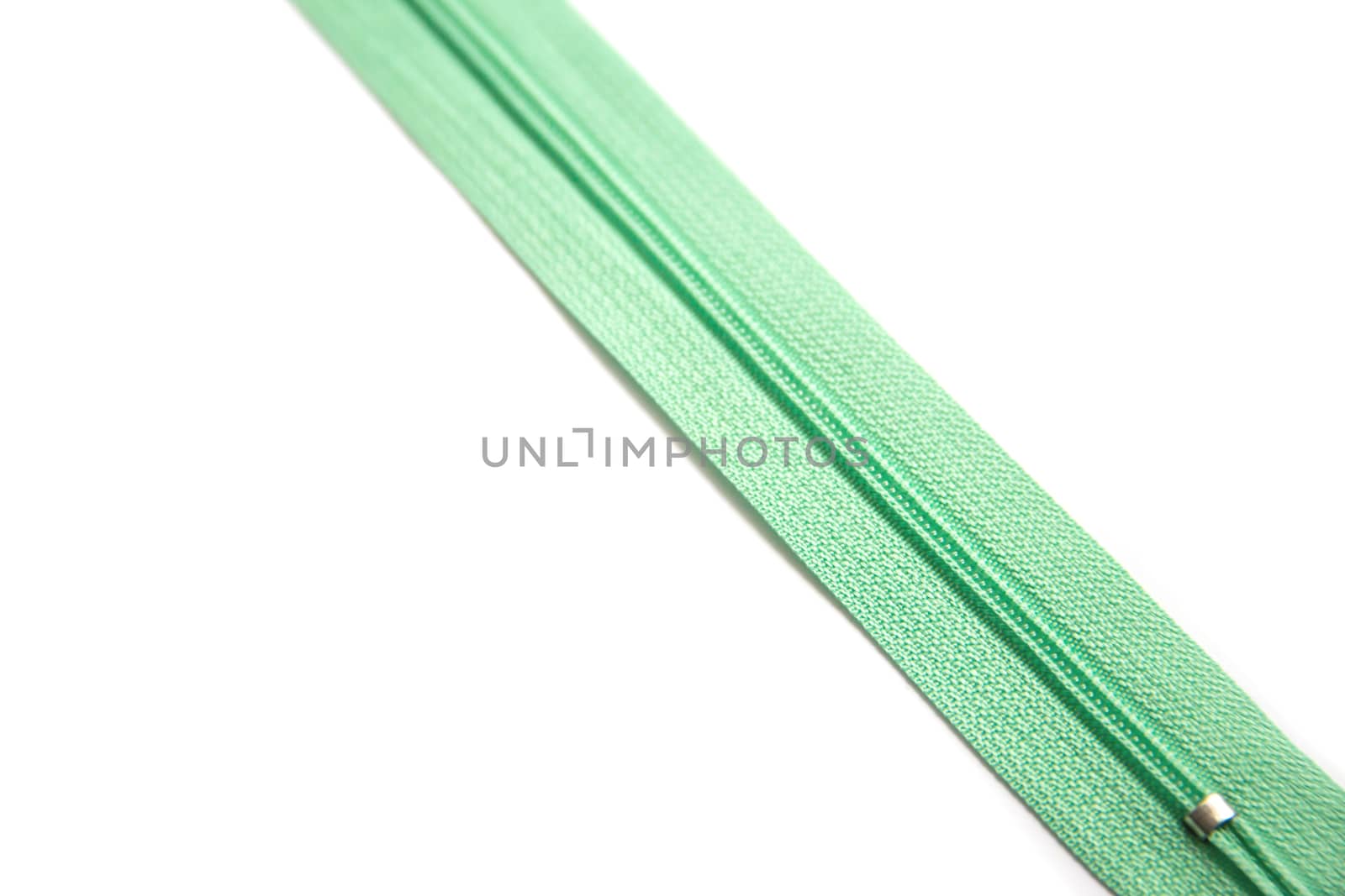 Green zipper isolated on white background