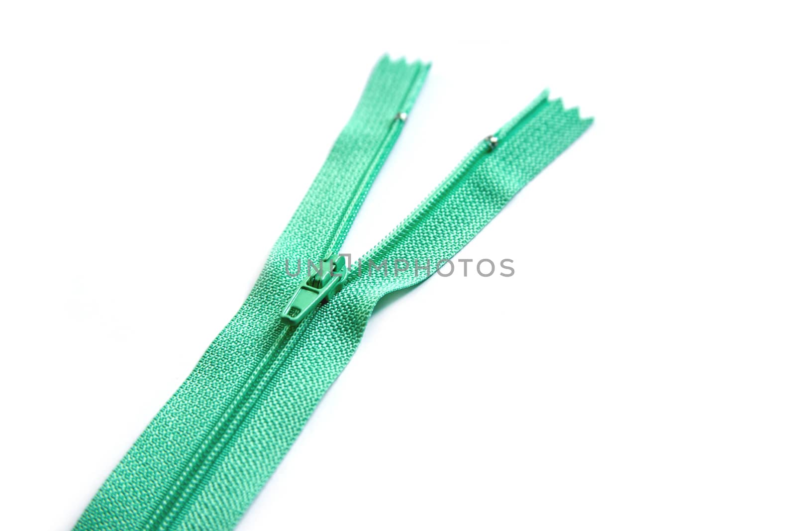 Green zipper isolated on white background