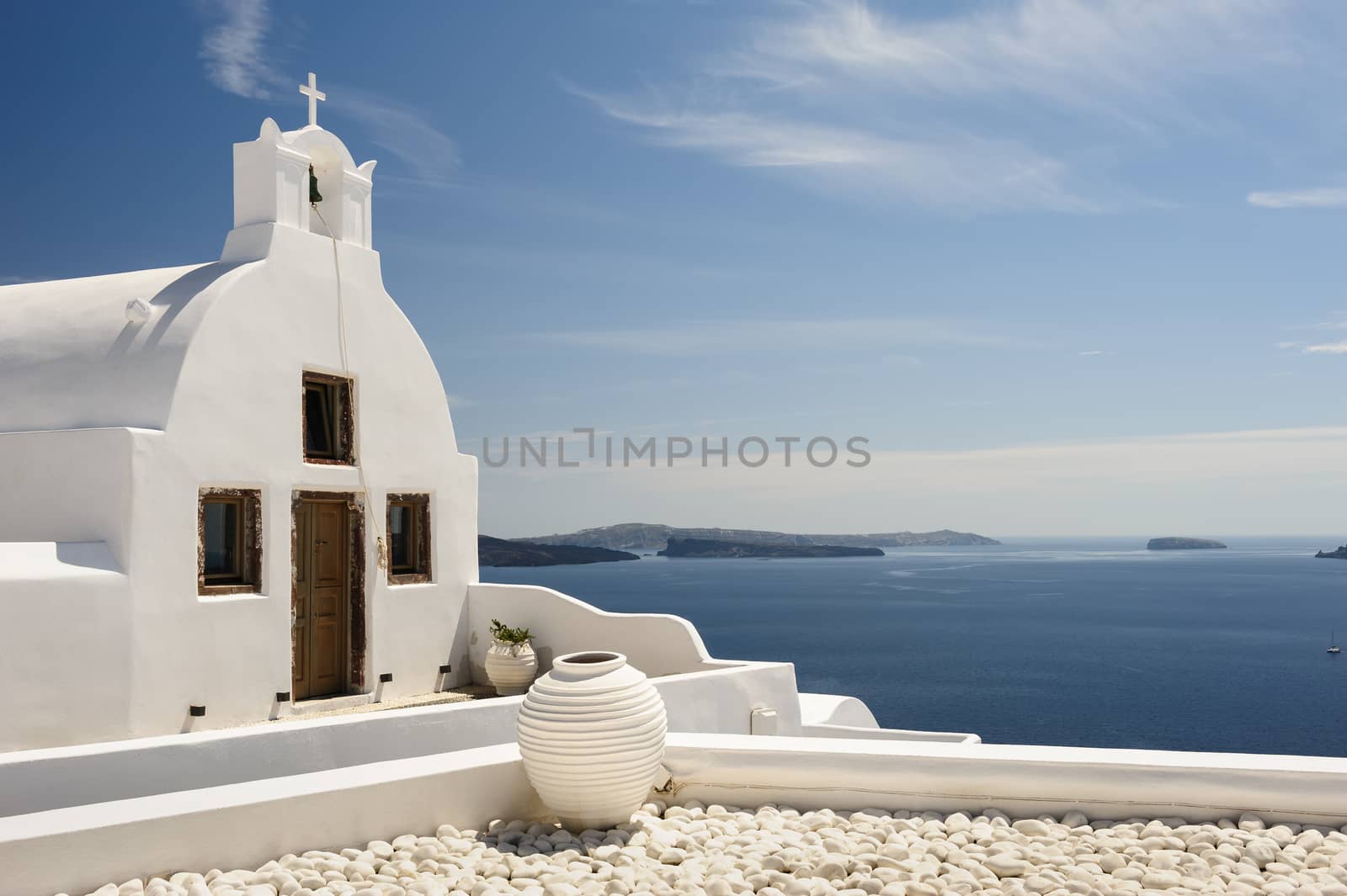 White orthodox church with bell tower. Oia, Santorini Greece. Copyspace