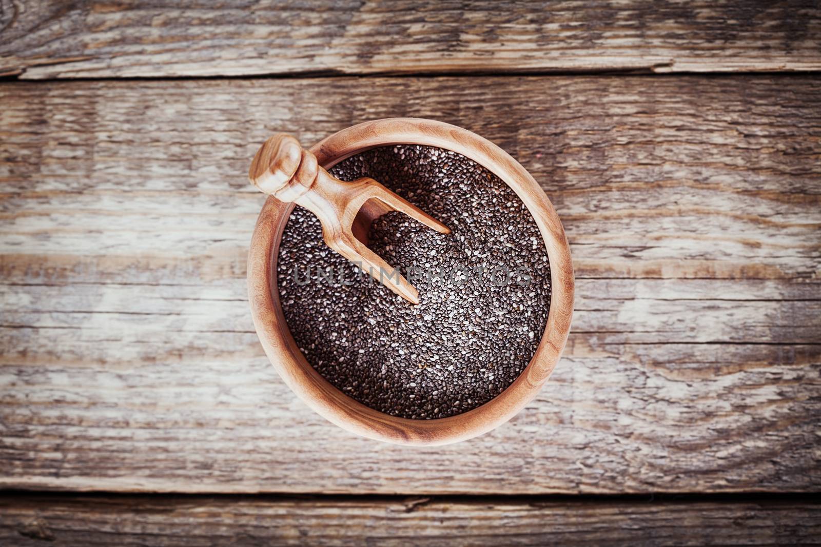 Chia Seeds with a spoon on a wooden table