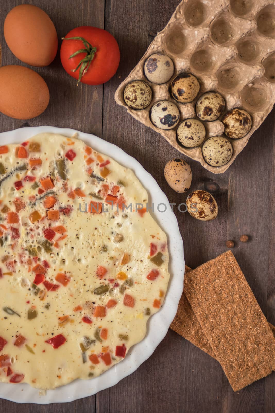 baked omelette with different eggs and vegetables with rye small load of bread