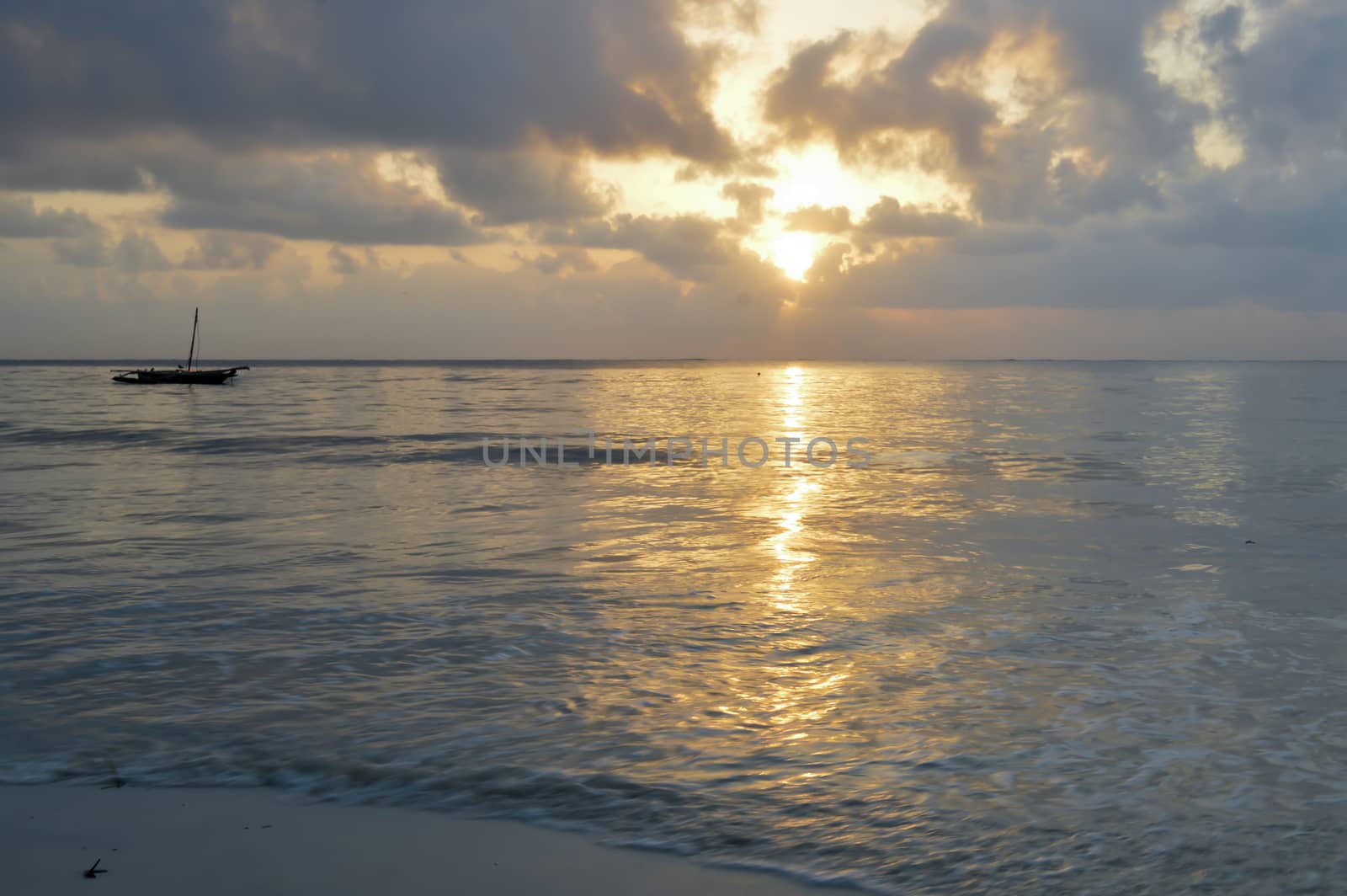 Dhow on the ocean at sunrise on Bamburi beach in Kenya