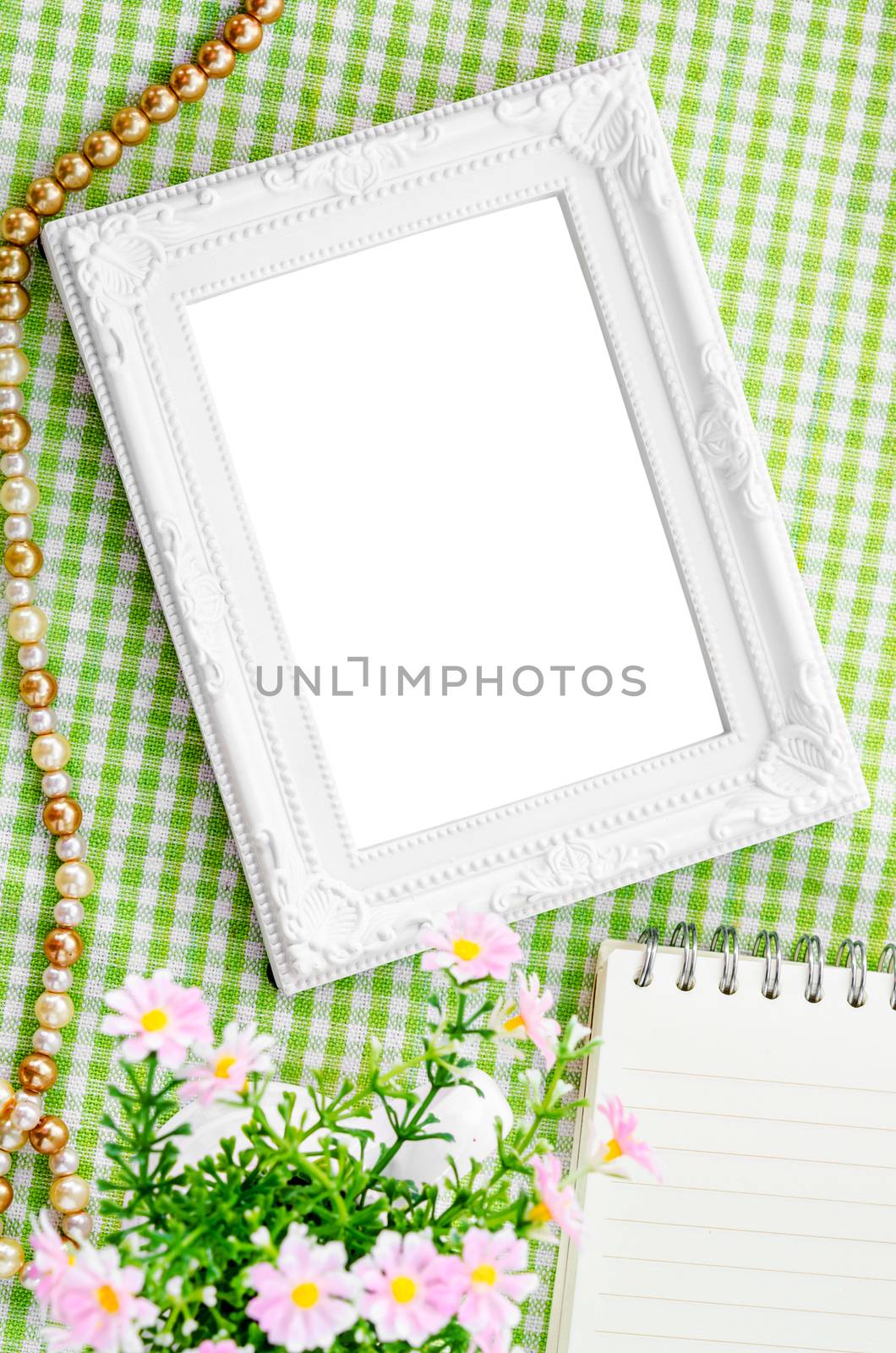 Vintage blank white photo frame with diary and flowe. Saved clipping path.