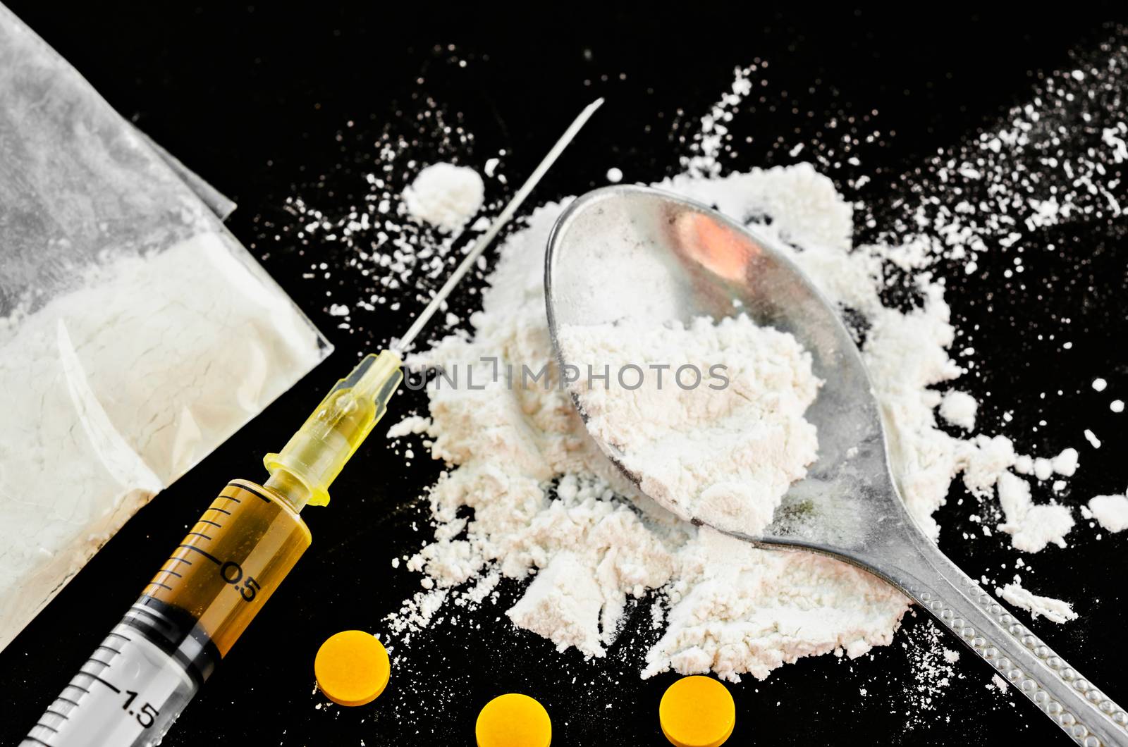 Drug syringe and cooked heroin. by Gamjai