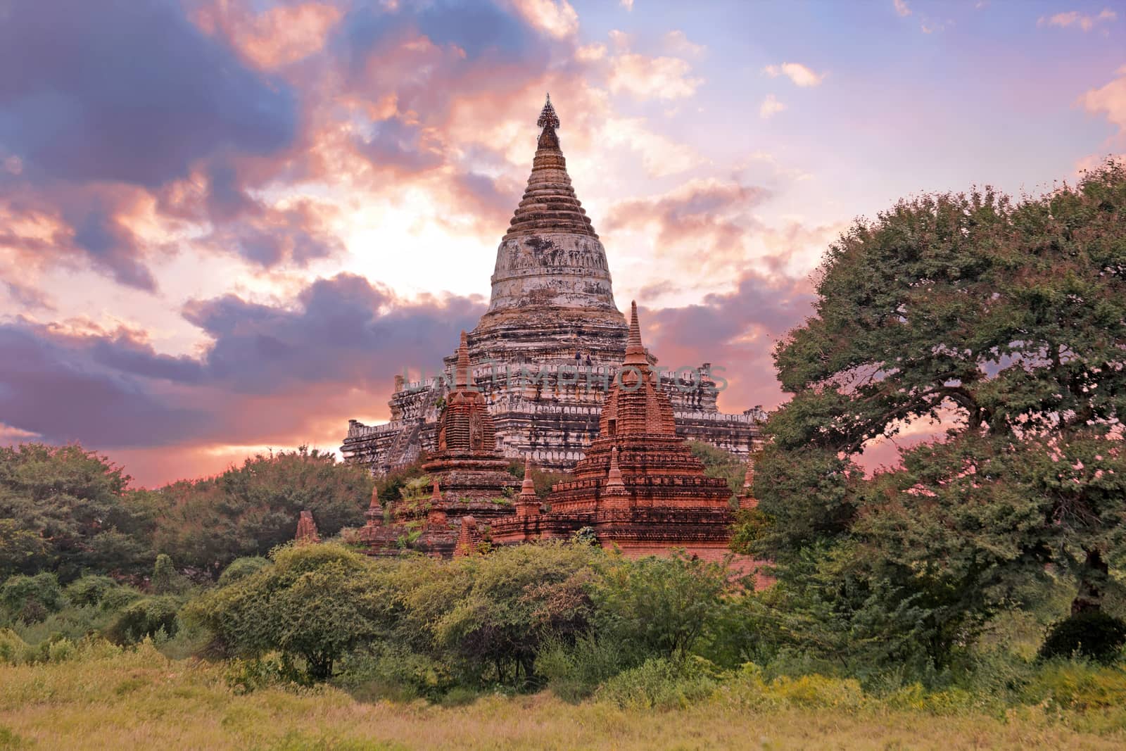 Ancient pagodas in the countryside from Bagan in Myanmar at sunset