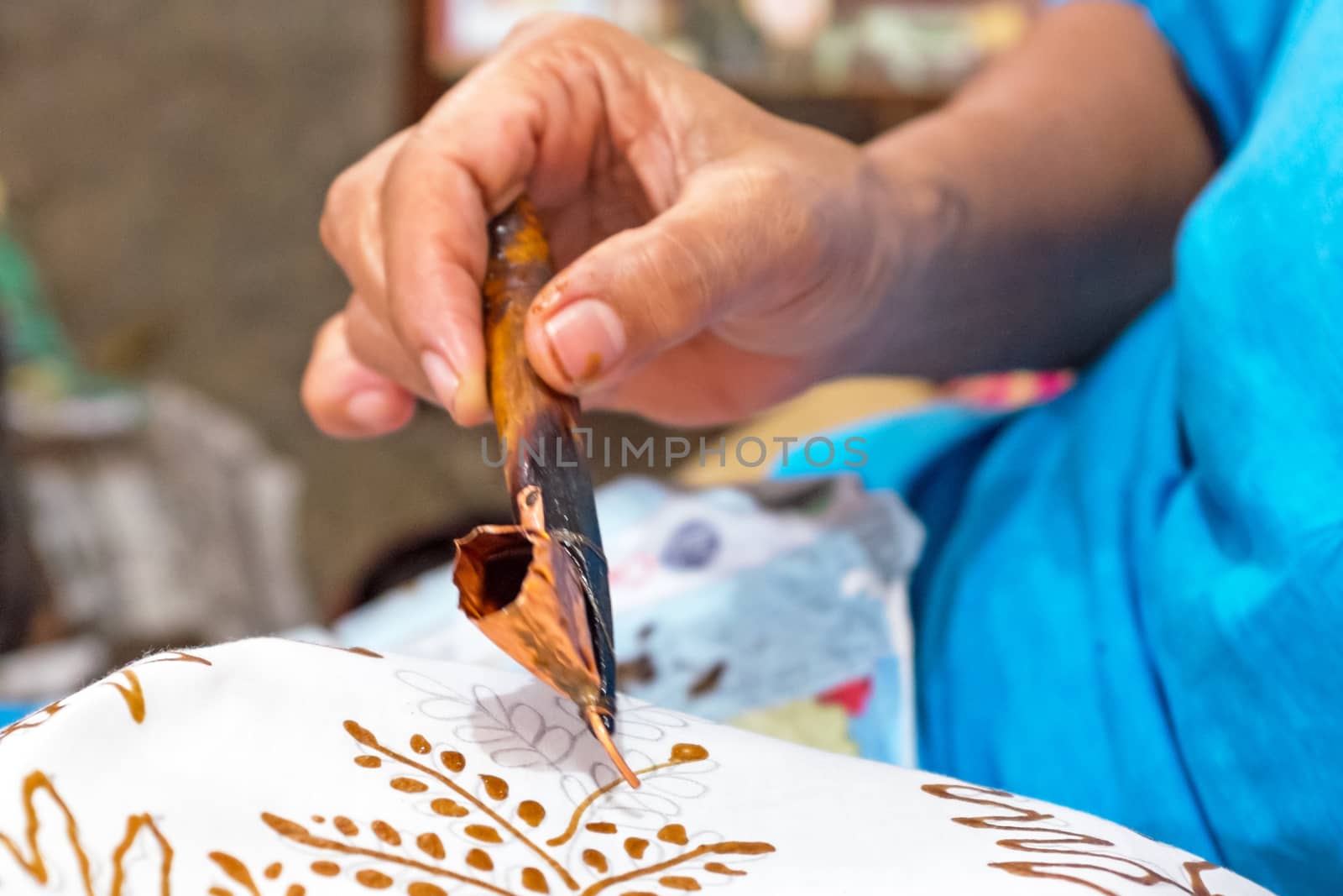 Painting watercolor on the fabric to make Batik. Batik-making is part of Indonesian culture