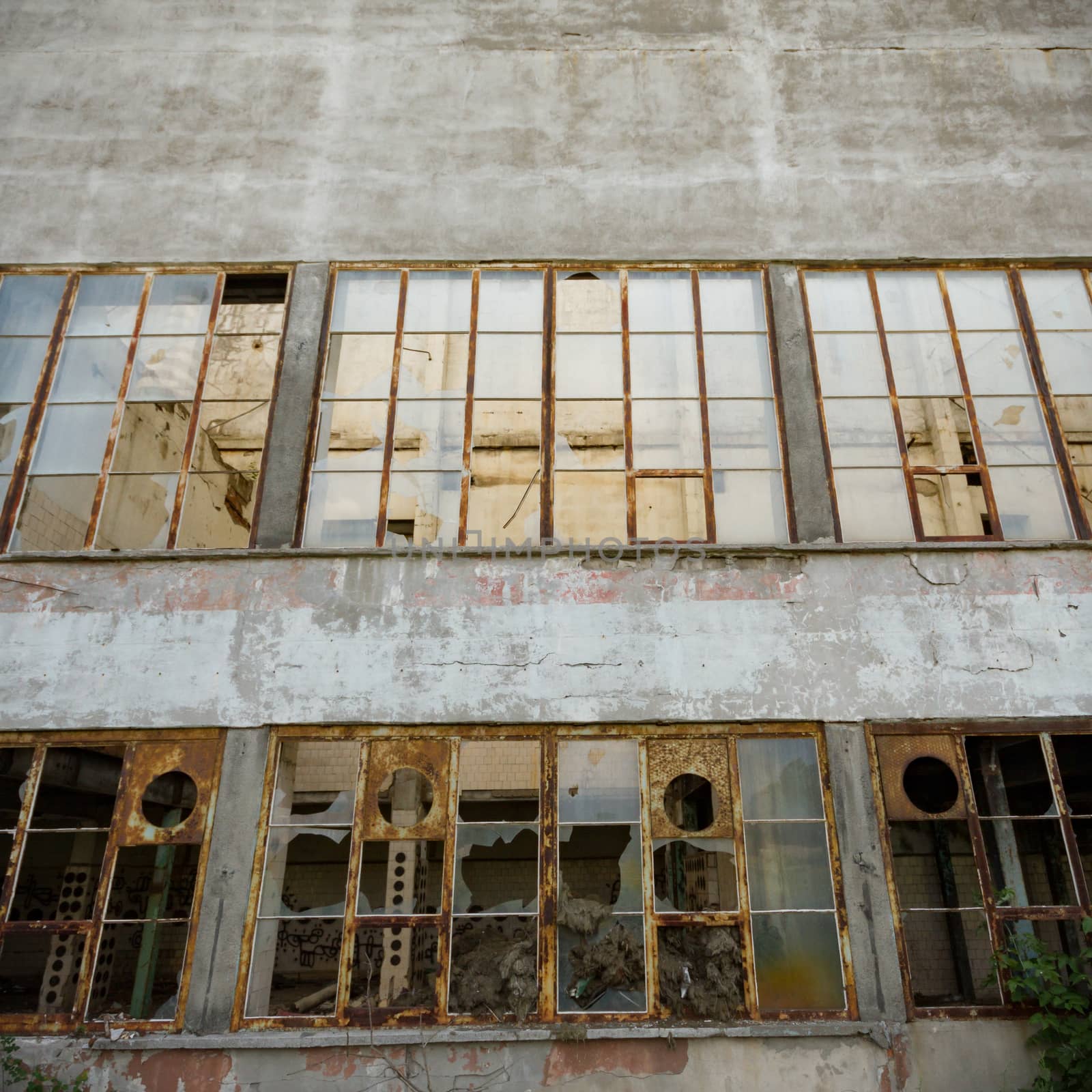 discarded ruin with old windows and wall, industrial window in concrete wall