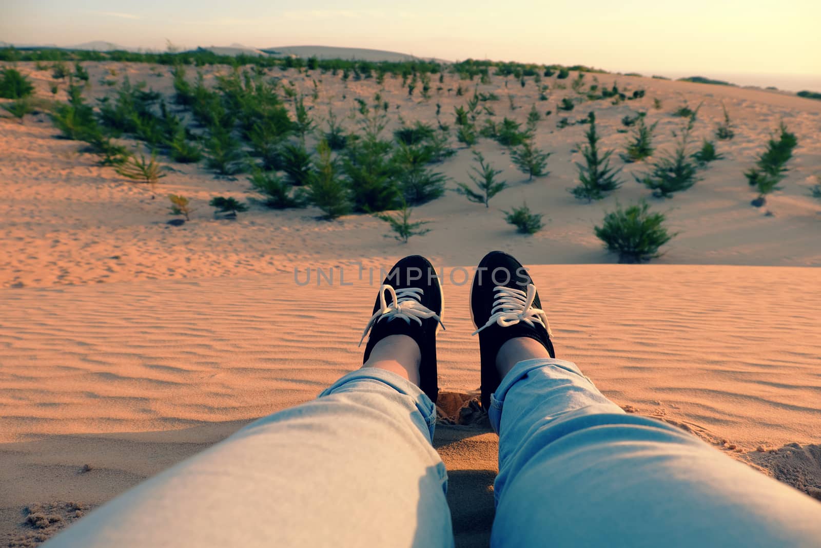 Summertime background with woman foot on sand hill, people relax on orange sandy under blue sky at Mui Ne, Phan Thiet, Vietnam, summer is coming and a trip to adventure make awesome life 