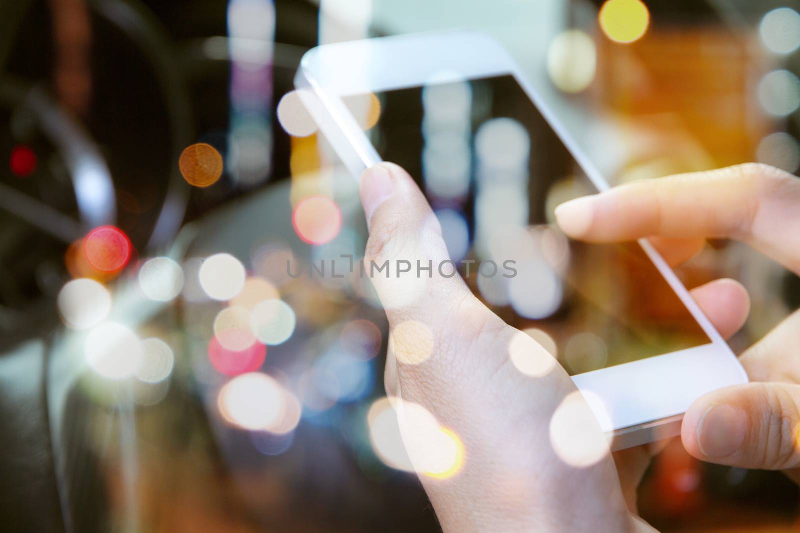 image of using a mobile phone inside of a car. communication networking