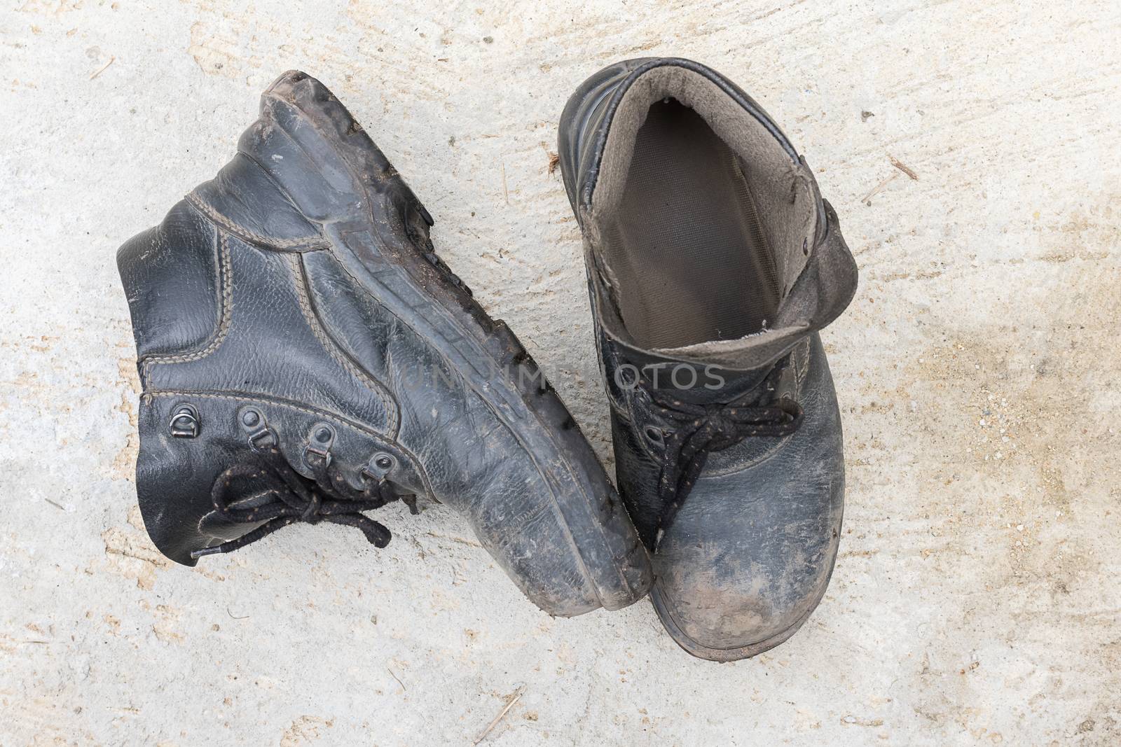 Safety leather man shoe on the cement floor texture background