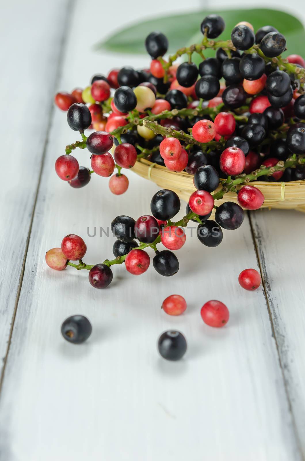 Thai Blueberry in bamboo basket over wooden background