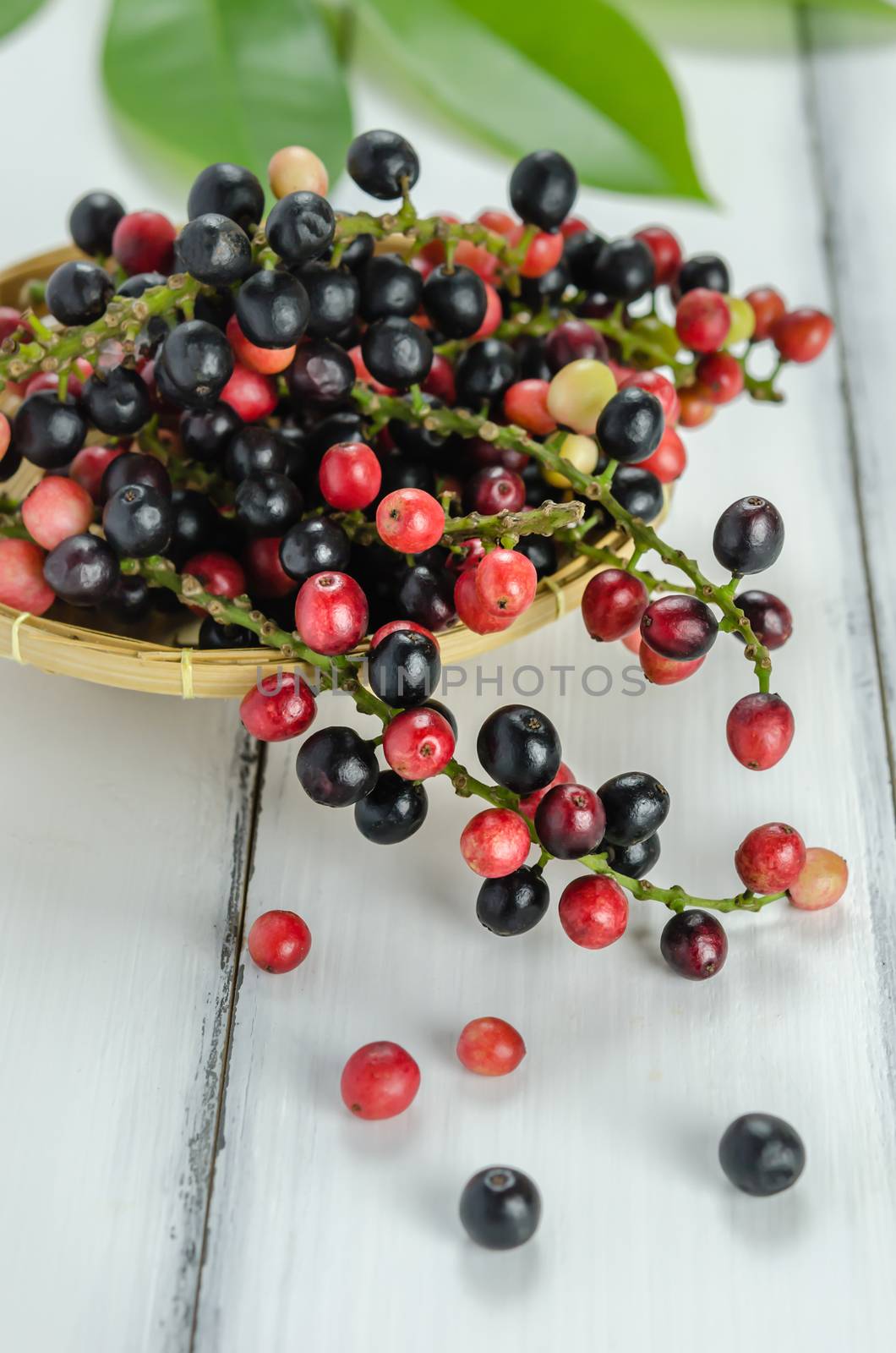 Thai Blueberry in bamboo basket over wooden background