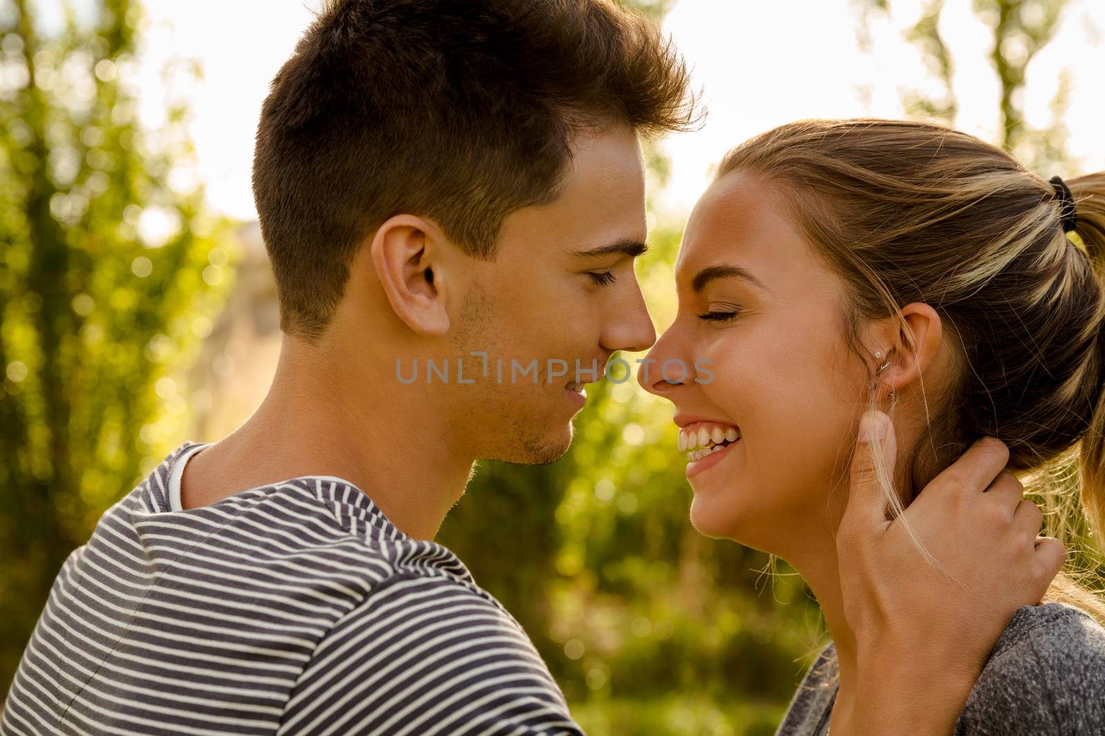 Portrait of a happy young couple in love and giving a kiss