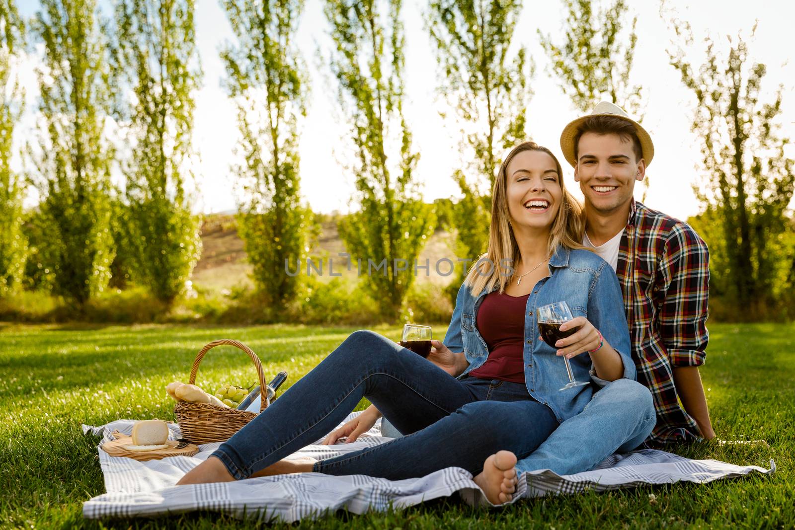 Shot of a beautiful couple on the park having fun together while making a picnic