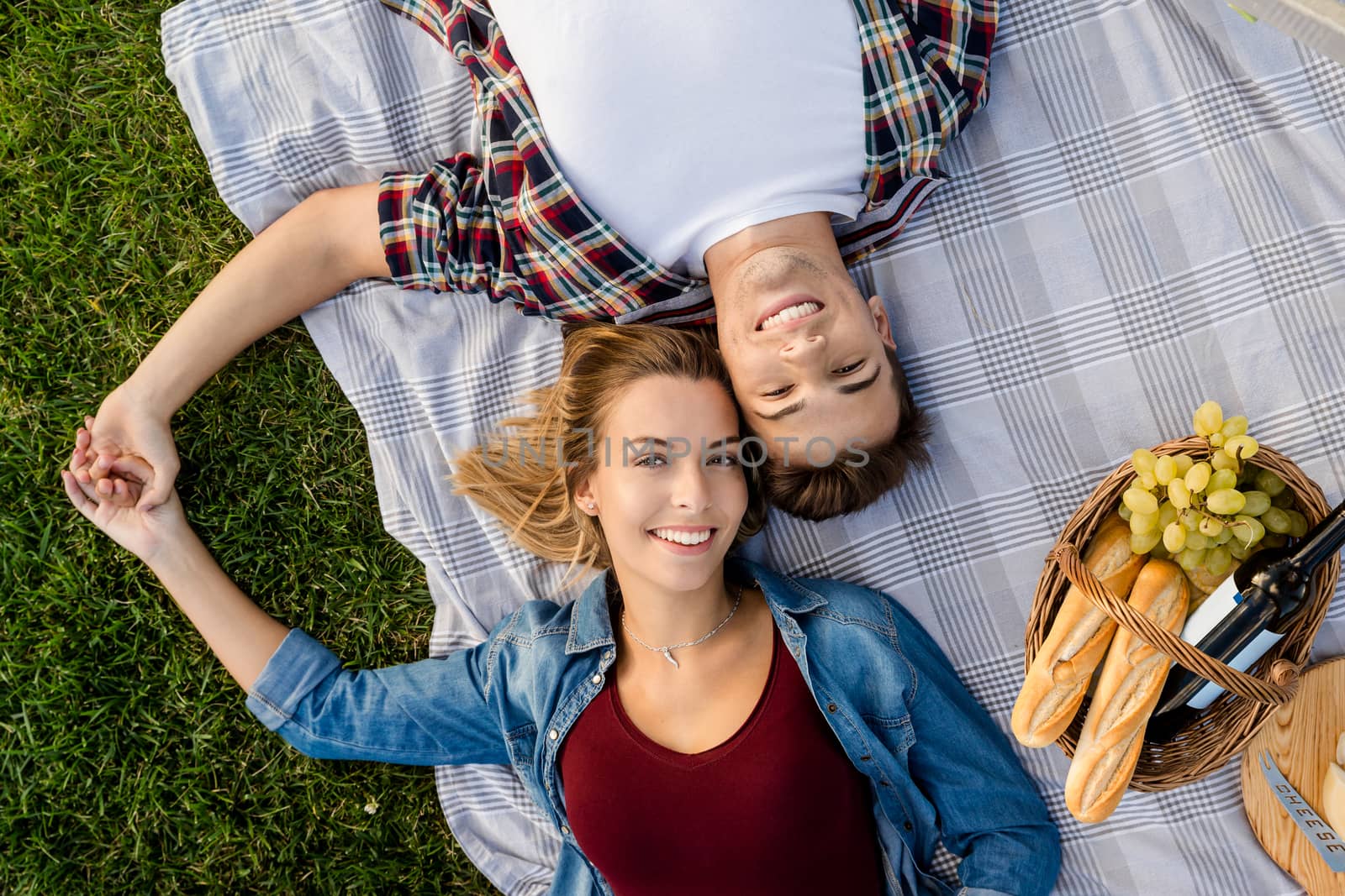 Happy young couple in the park relaxing after the picnic