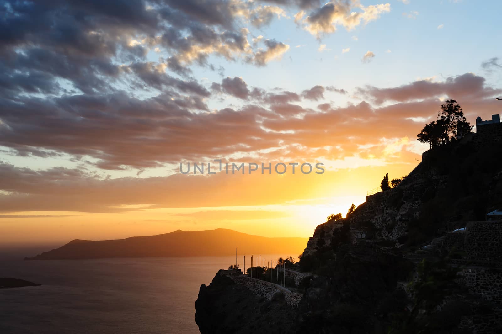 Dramatic colorful sunset at Santorini, Greece. View to caldera sea.
