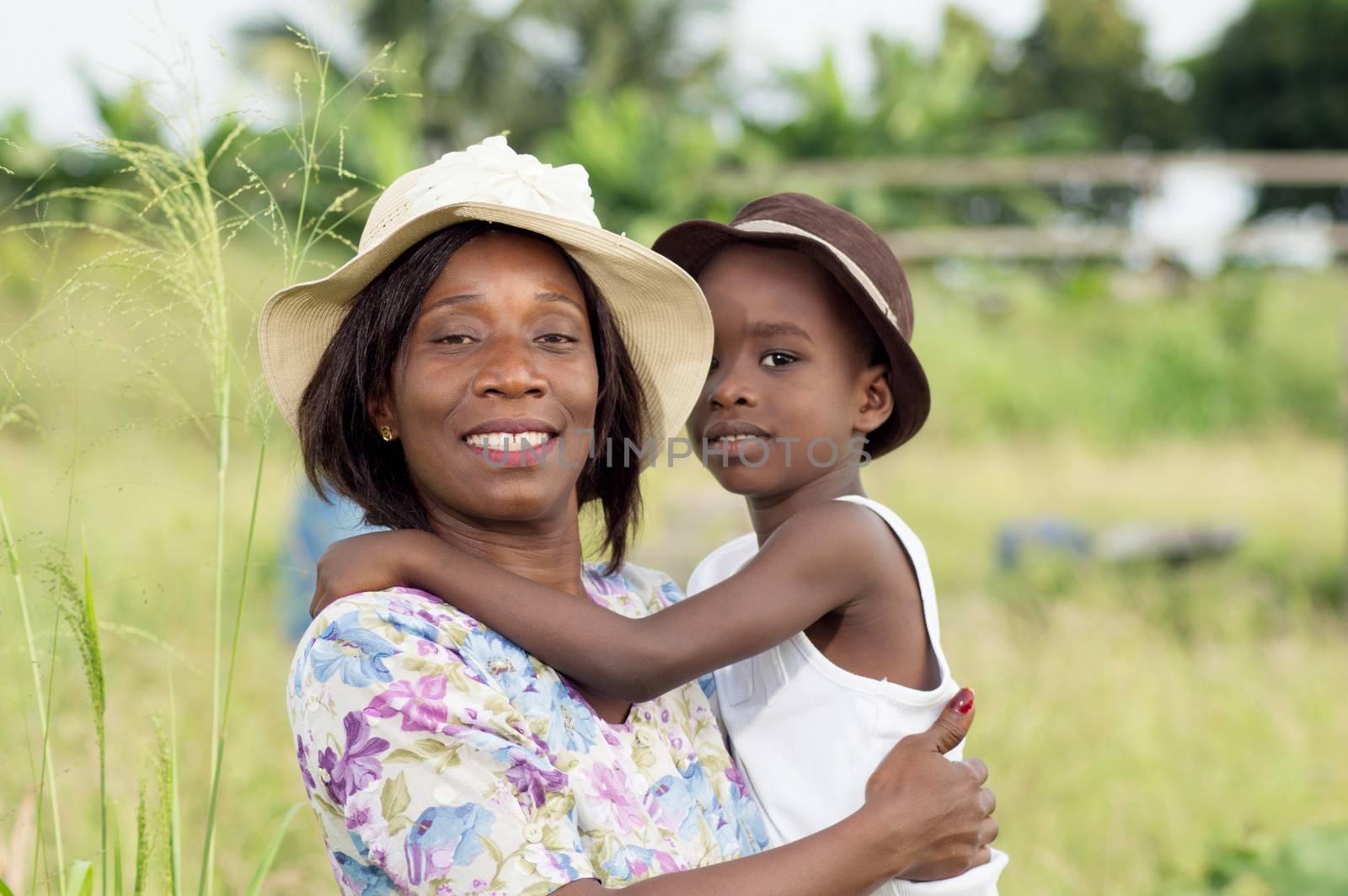 This  young woman carrying her child because he is tired of walking.