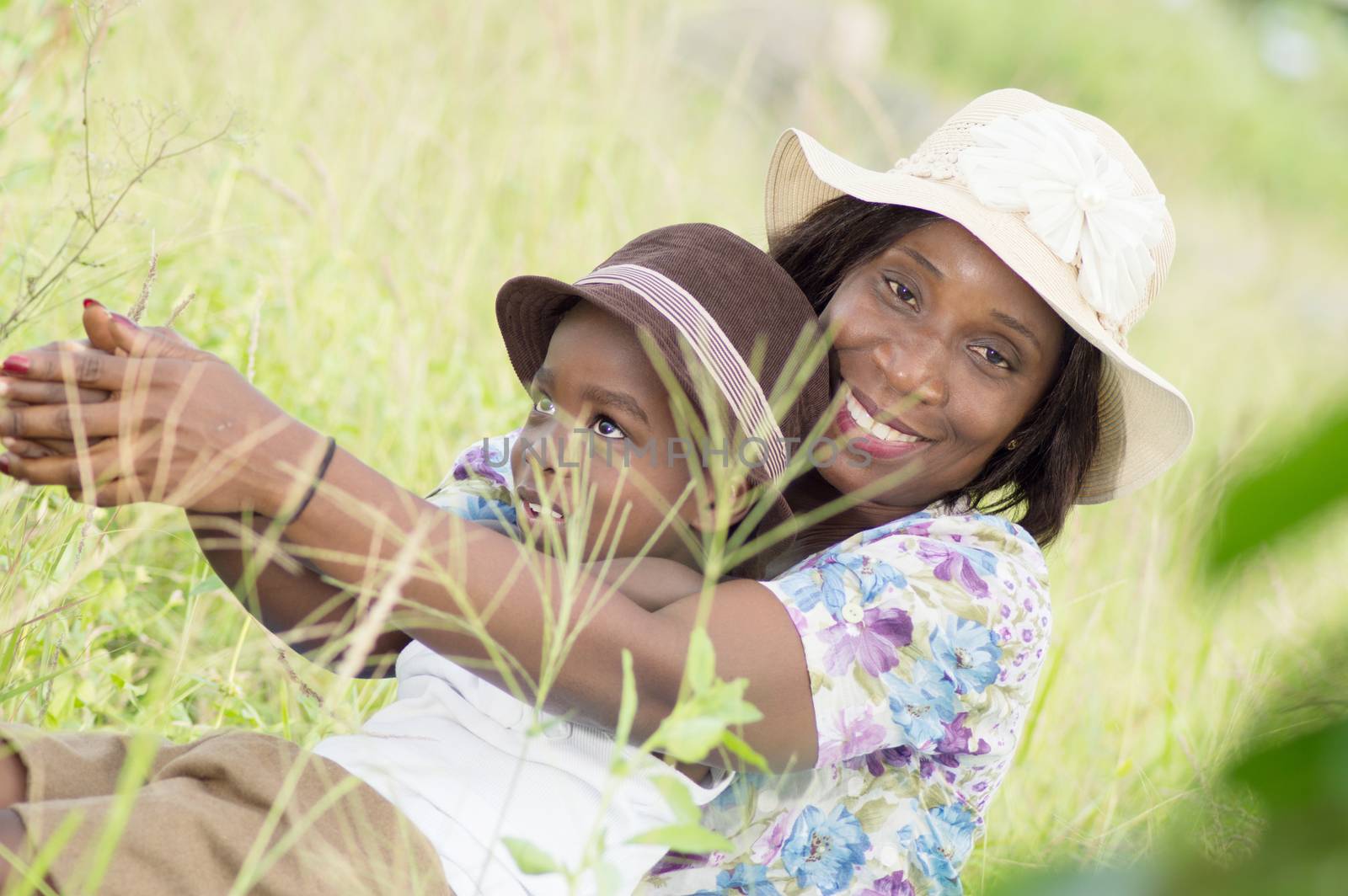This young woman and her child playing in the grass.