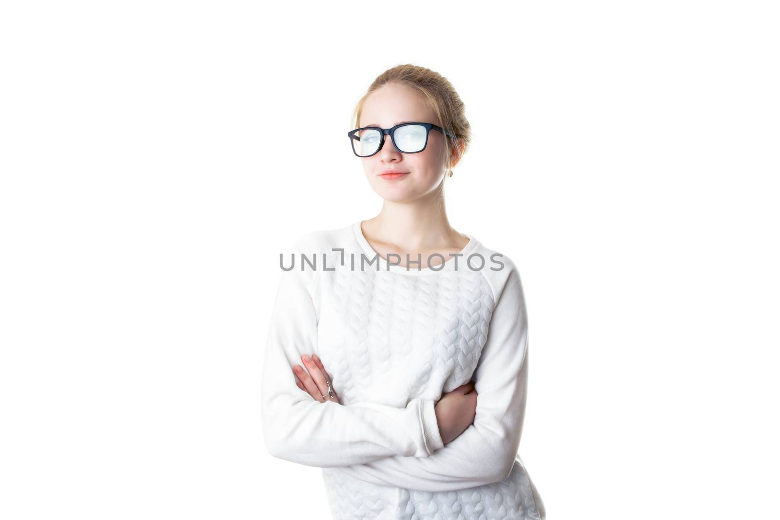 Girl teenager in glasses with flare effect. Young woman in glasses and a white sweater, crossed her arms and smiles. Isolated on white background