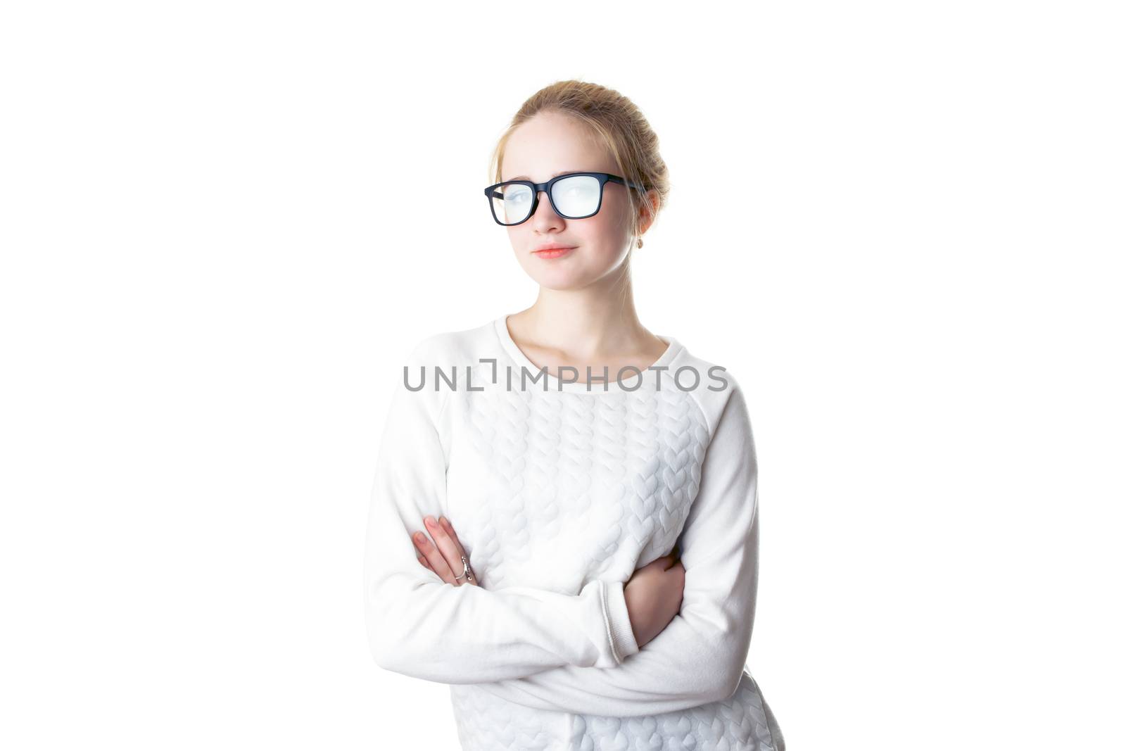 Girl teenager in glasses with flare effect. Young woman in glasses and a white sweater, crossed her arms and smiles. Isolated on white background