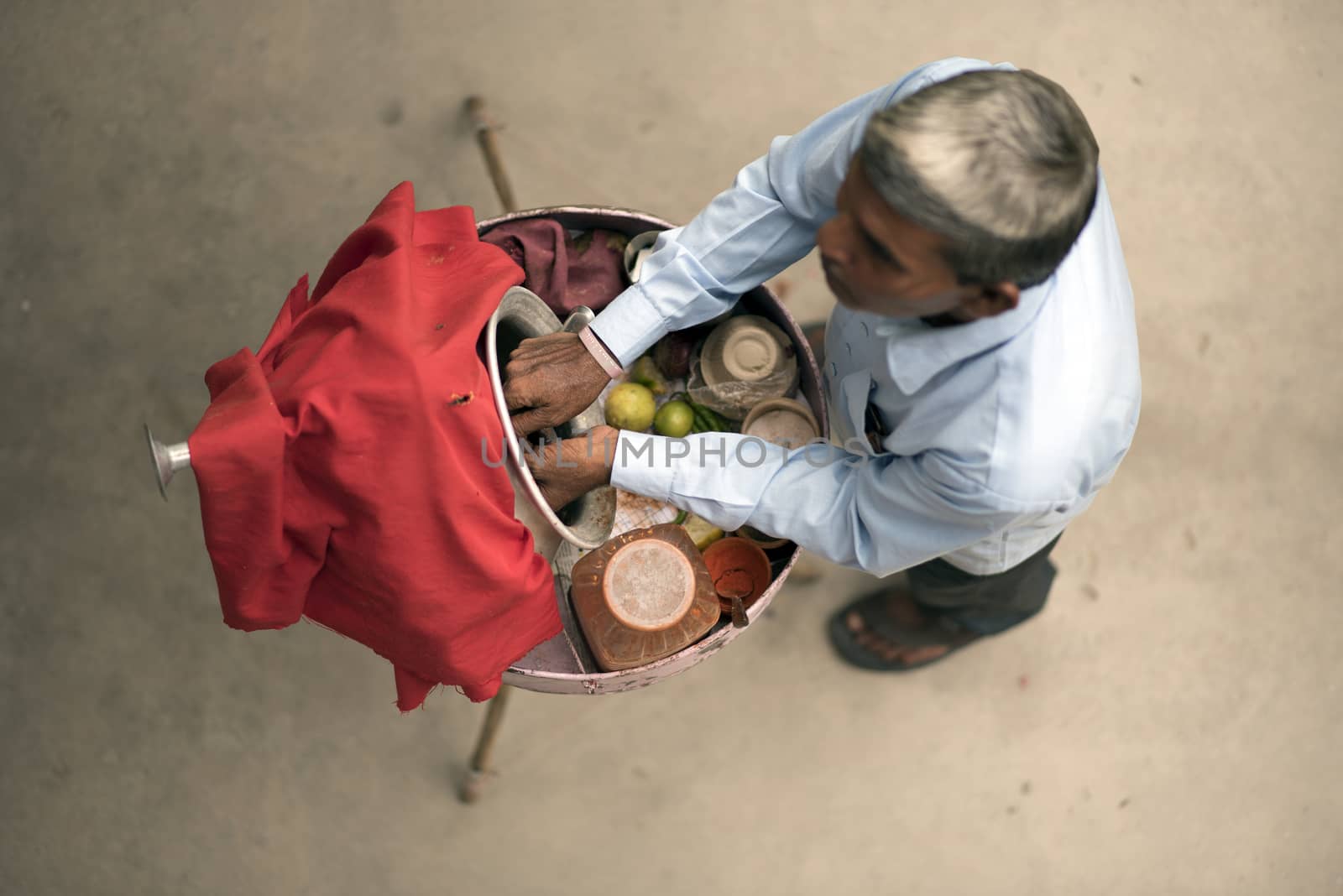 Elevated view of a hawker selling street food, chaat, outdoor in India.