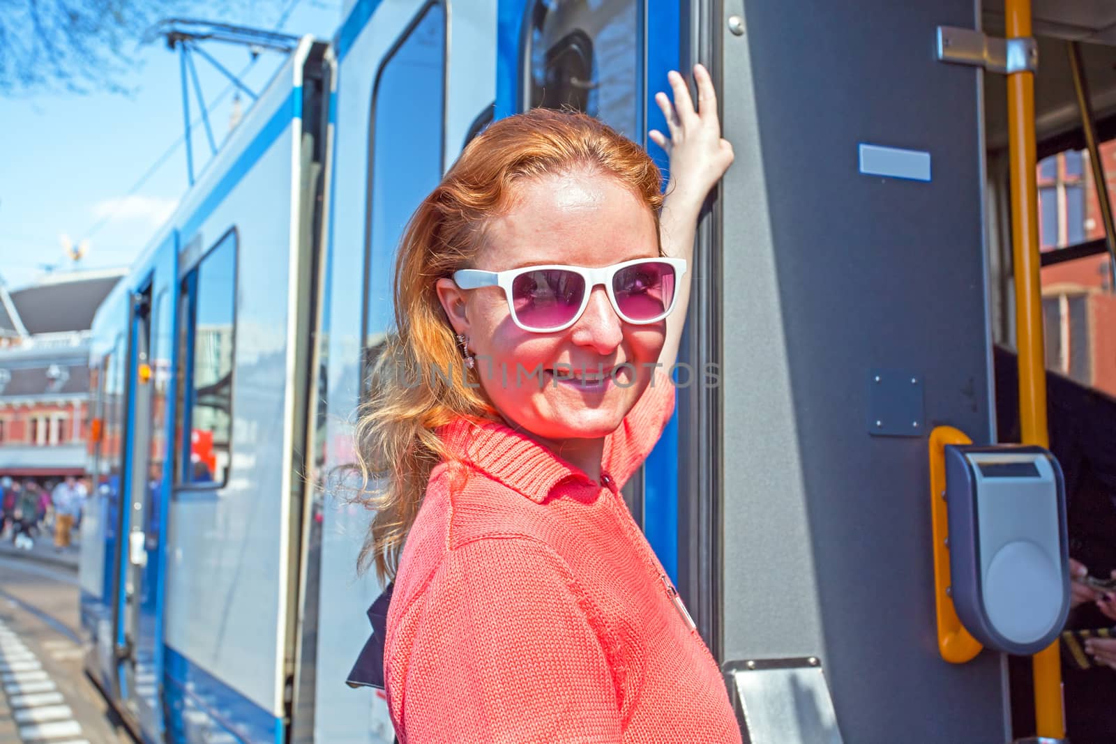 Young native dutch woman getting on the tram in Amsterdam the Netherlands