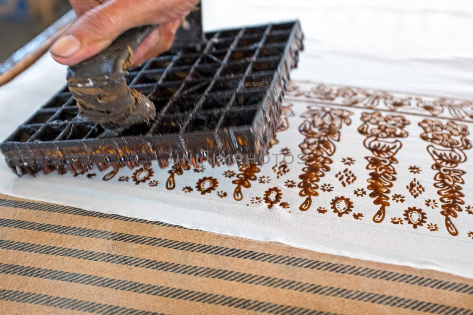 Block printing on the fabric to make Batik 'Batik making is part of the indonesian culture