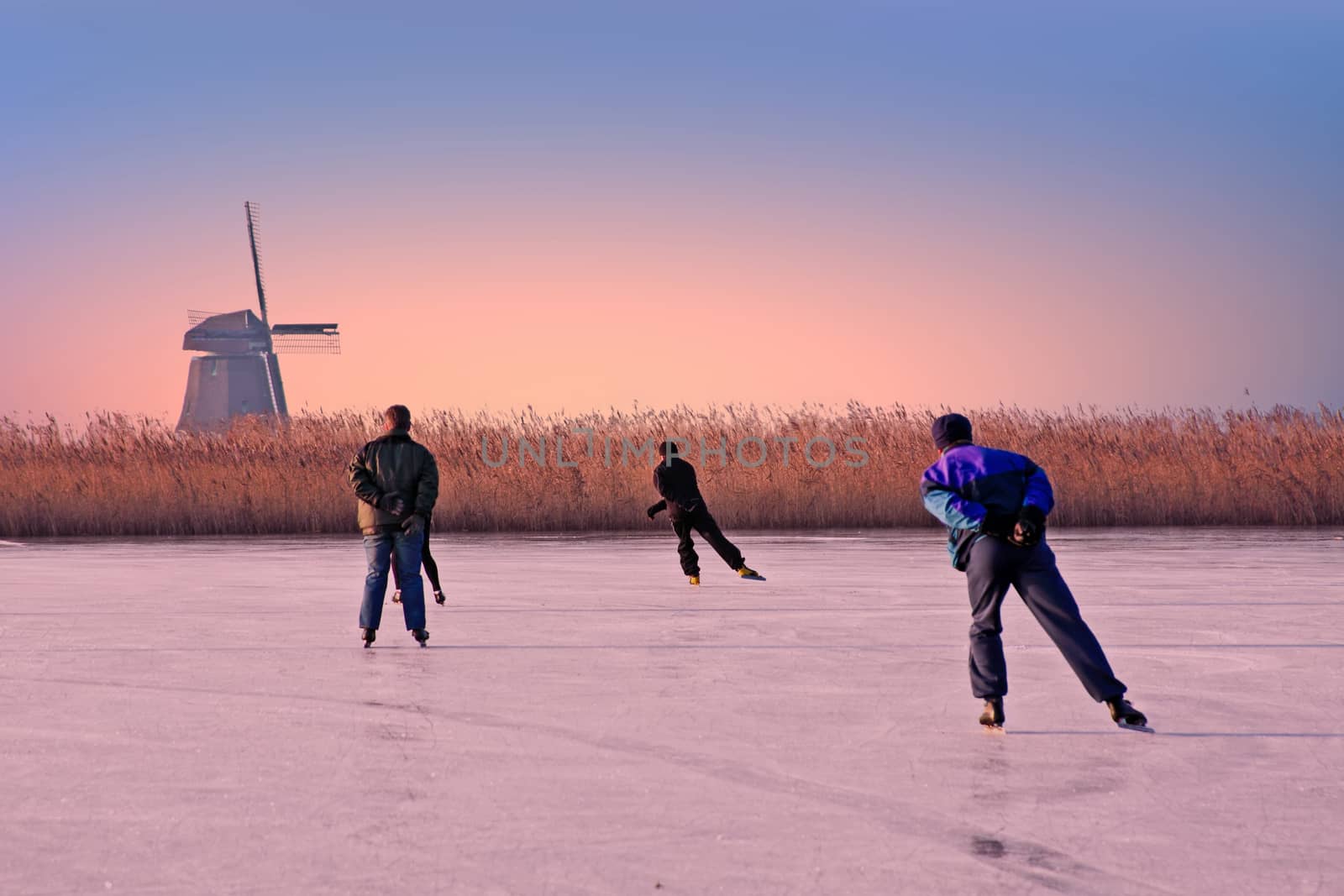 Ice skating in the countryside from the Netherlands at sunset