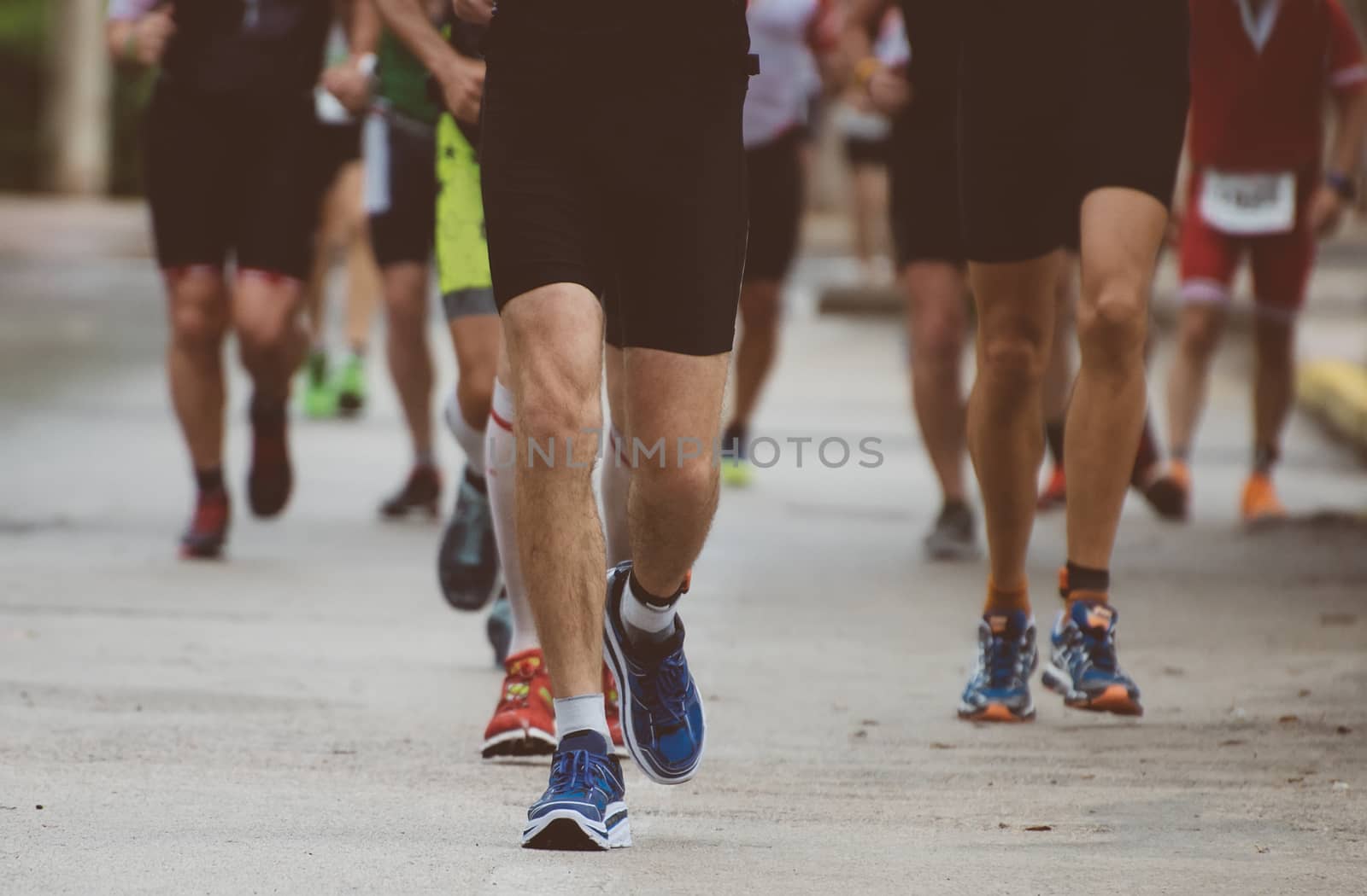 Group of marathon runners on the street. by dmitrimaruta