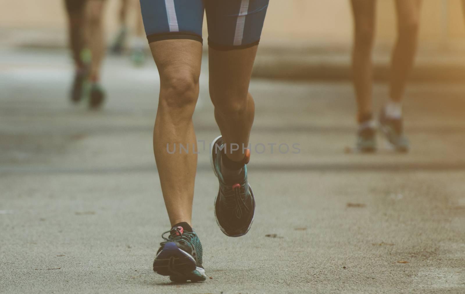 Group of marathon runners on the street. by dmitrimaruta