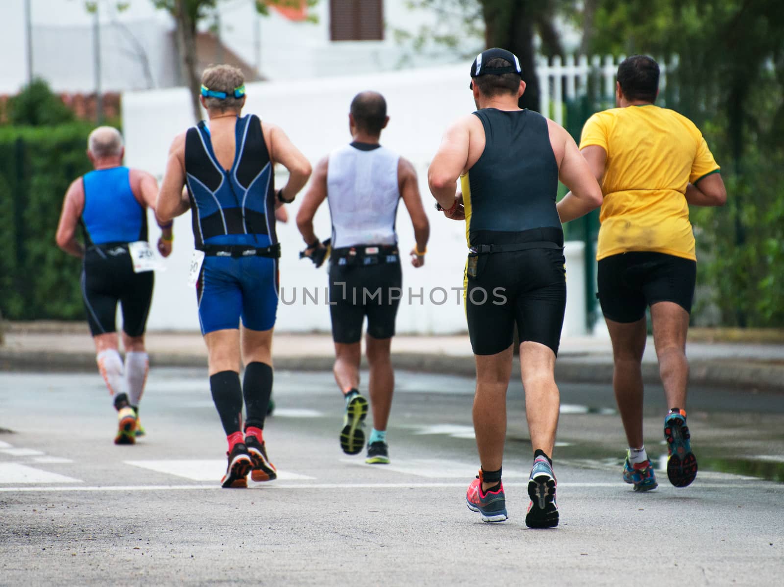 Group of marathon runners on the street. by dmitrimaruta