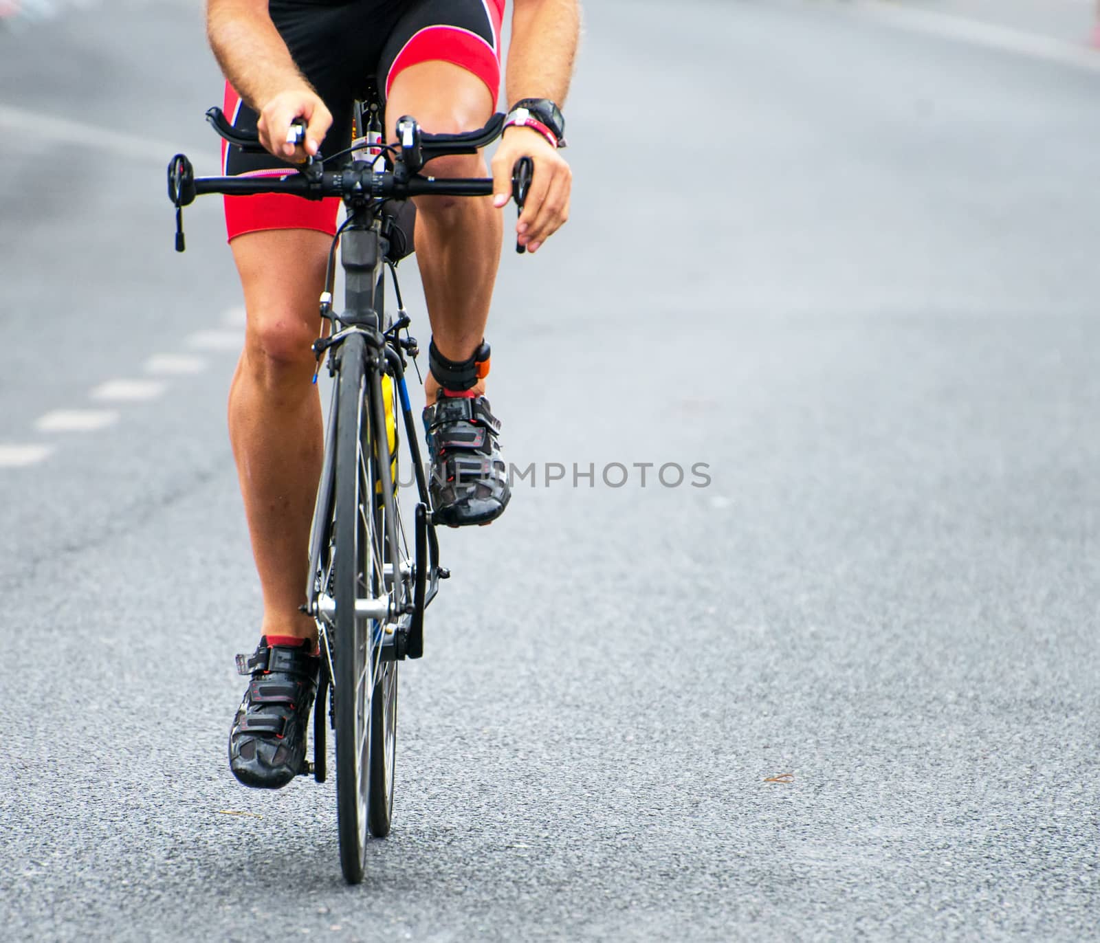 Unrecognizable professional cyclist during the bicycle competition. by dmitrimaruta