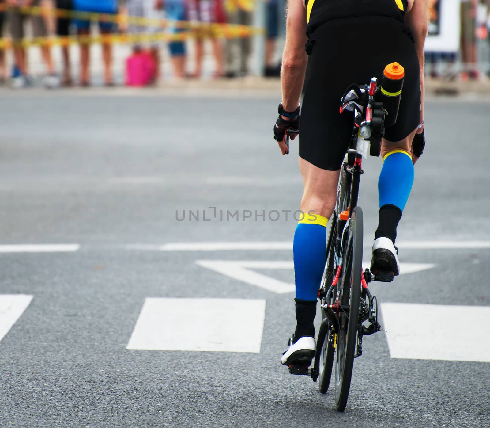 Unrecognizable professional cyclist during the bicycle competition. Back view. by dmitrimaruta