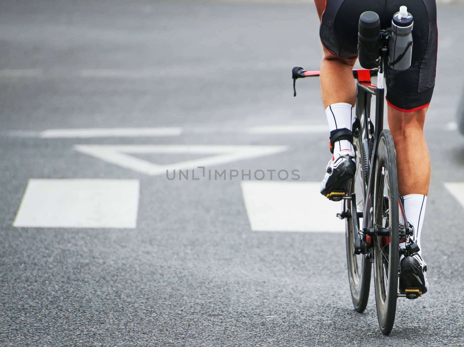 Unrecognizable professional cyclist during the bicycle competition. Back view.