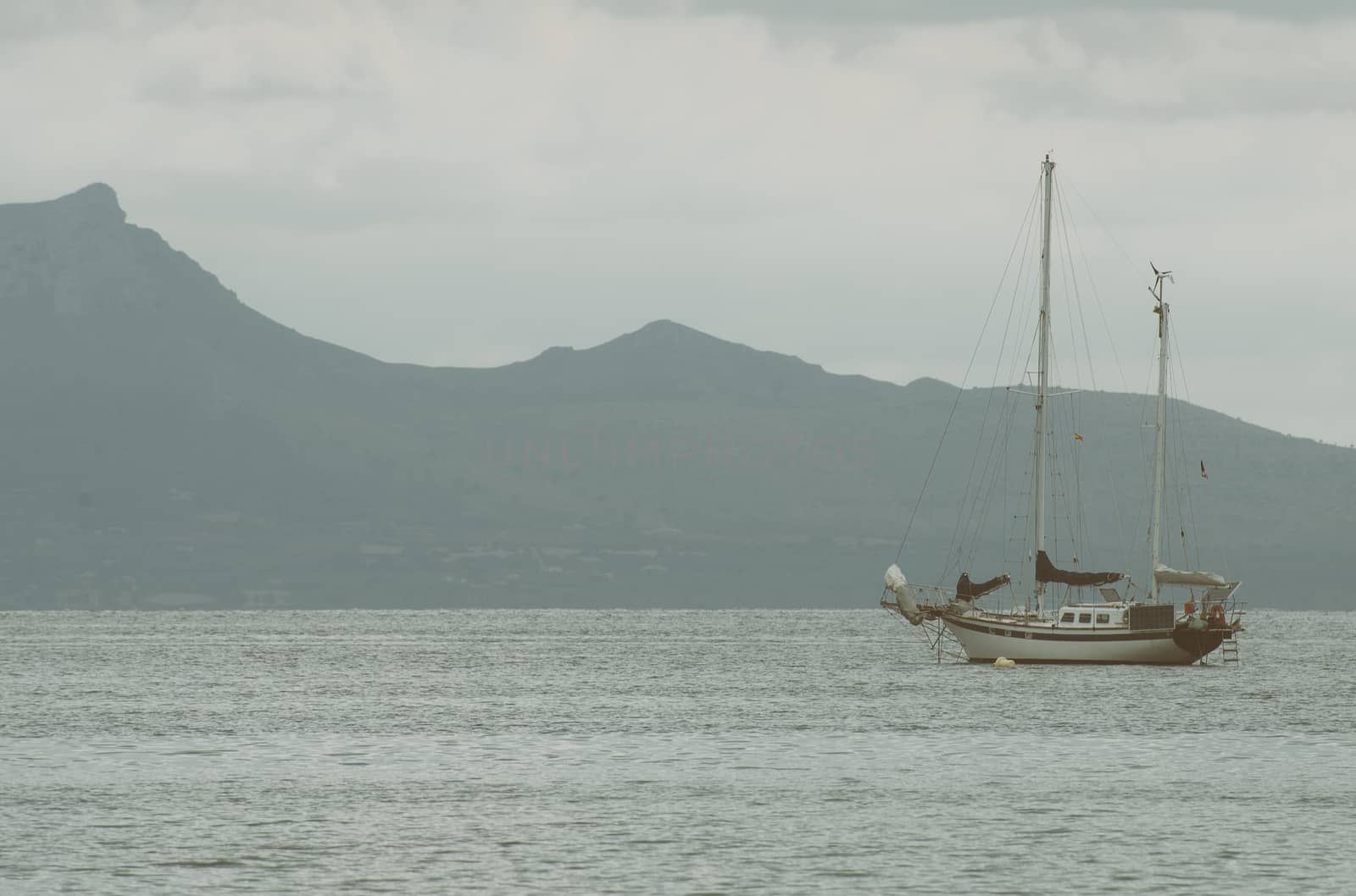 Yacht with solar panels in the bay at morning.