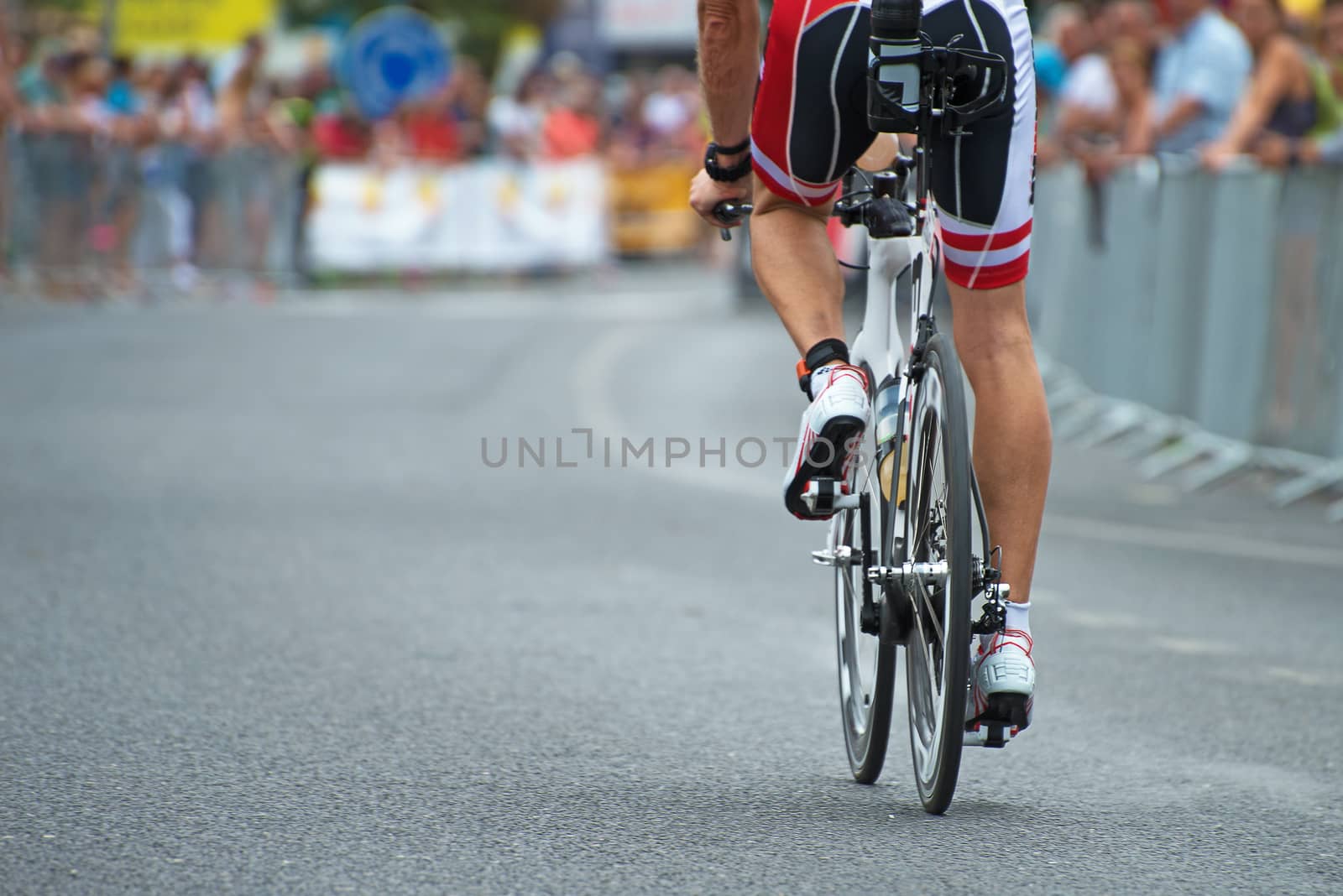 Unrecognizable professional cyclist during the bicycle competition. Back view.