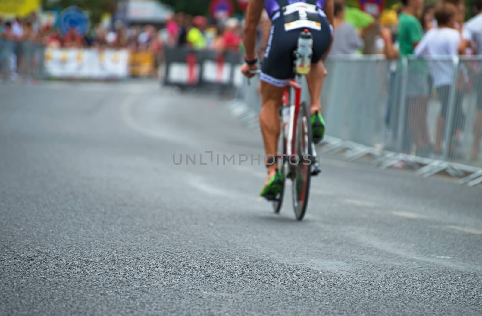 Unrecognizable professional cyclist during the bicycle competition. Back view.