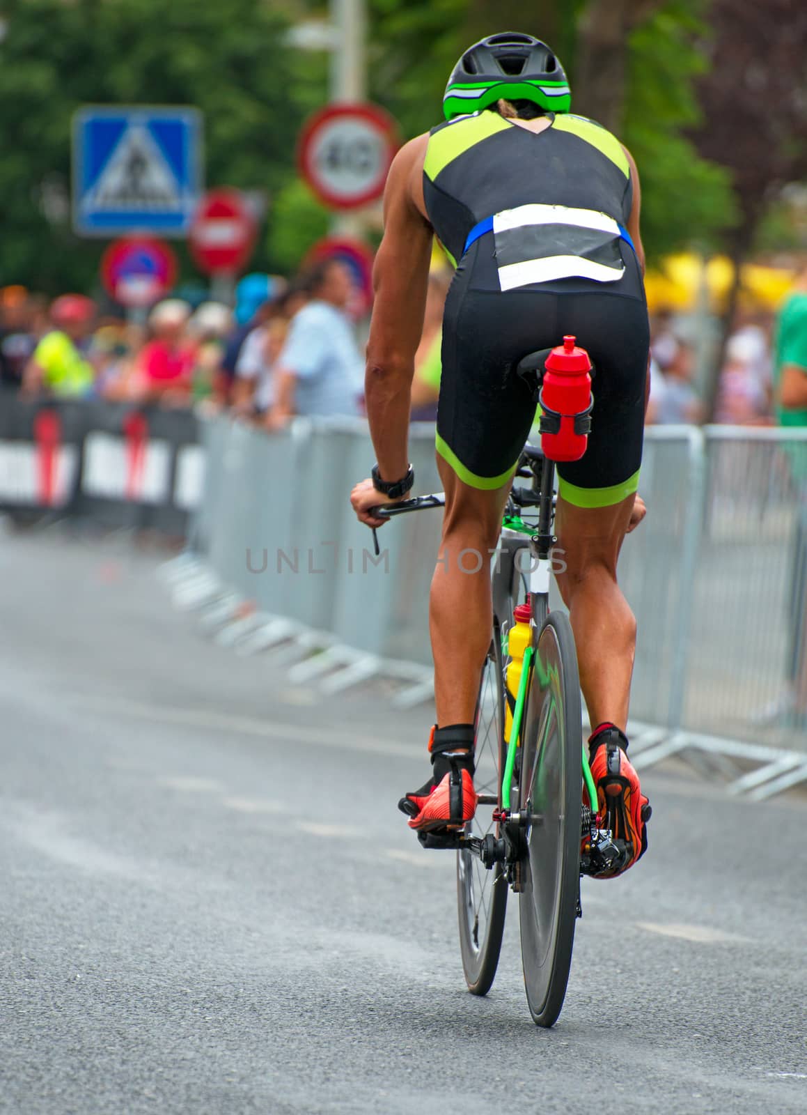 Unrecognizable professional cyclist during the bicycle competition. Back view. by dmitrimaruta