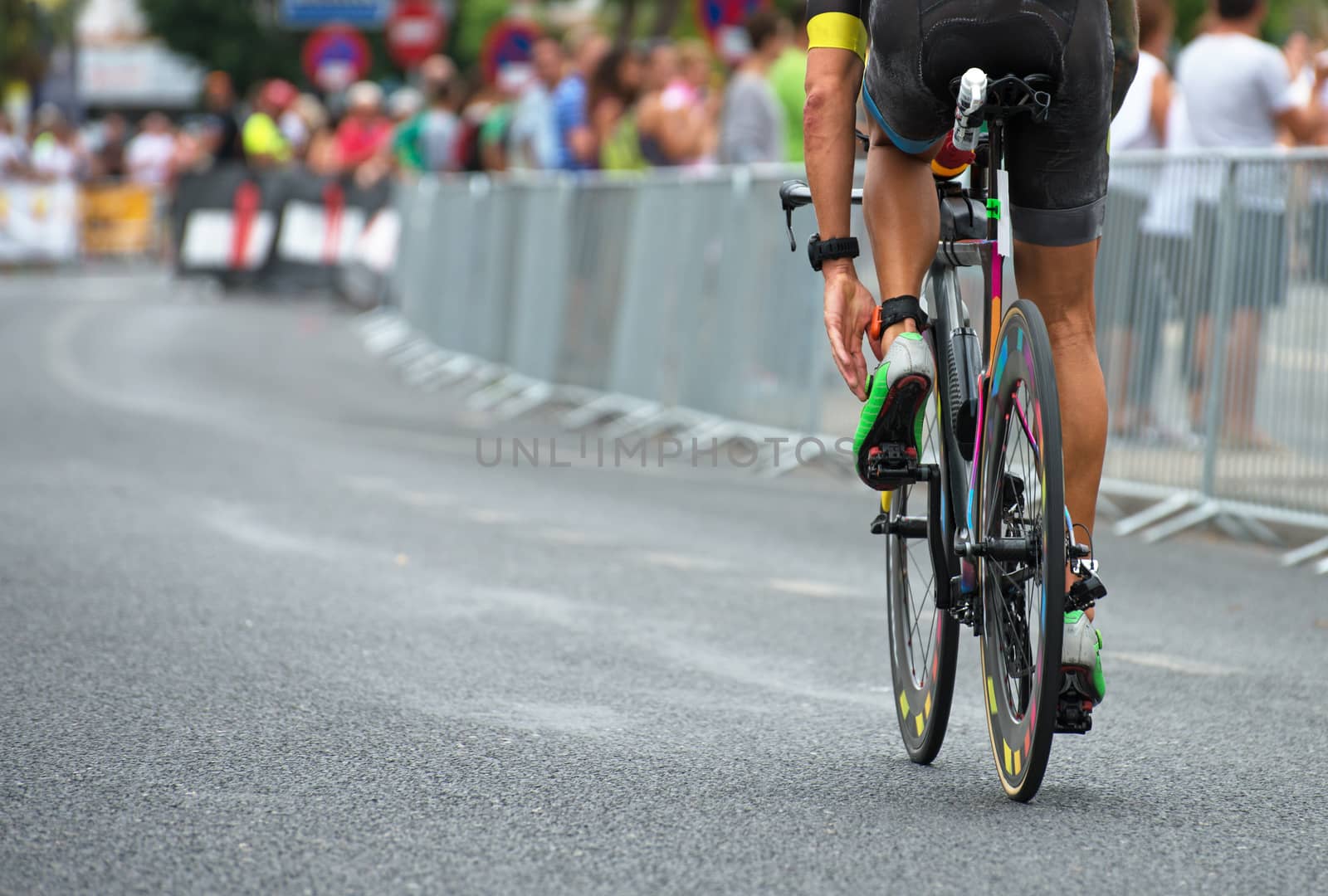 Unrecognizable professional cyclist during the bicycle competition. Back view. by dmitrimaruta