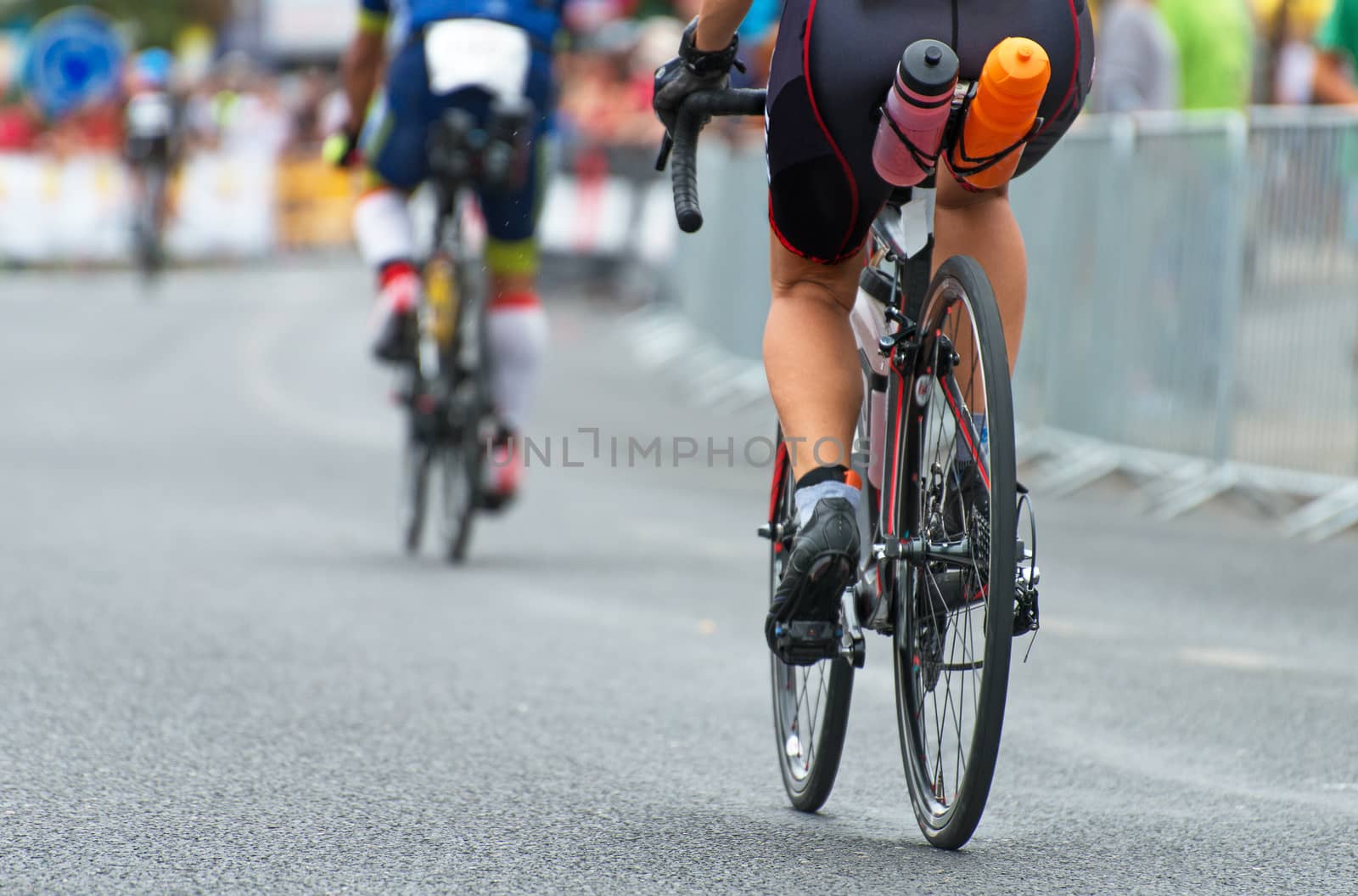 Unrecognizable professional cyclists during the bicycle competition. Back view. by dmitrimaruta