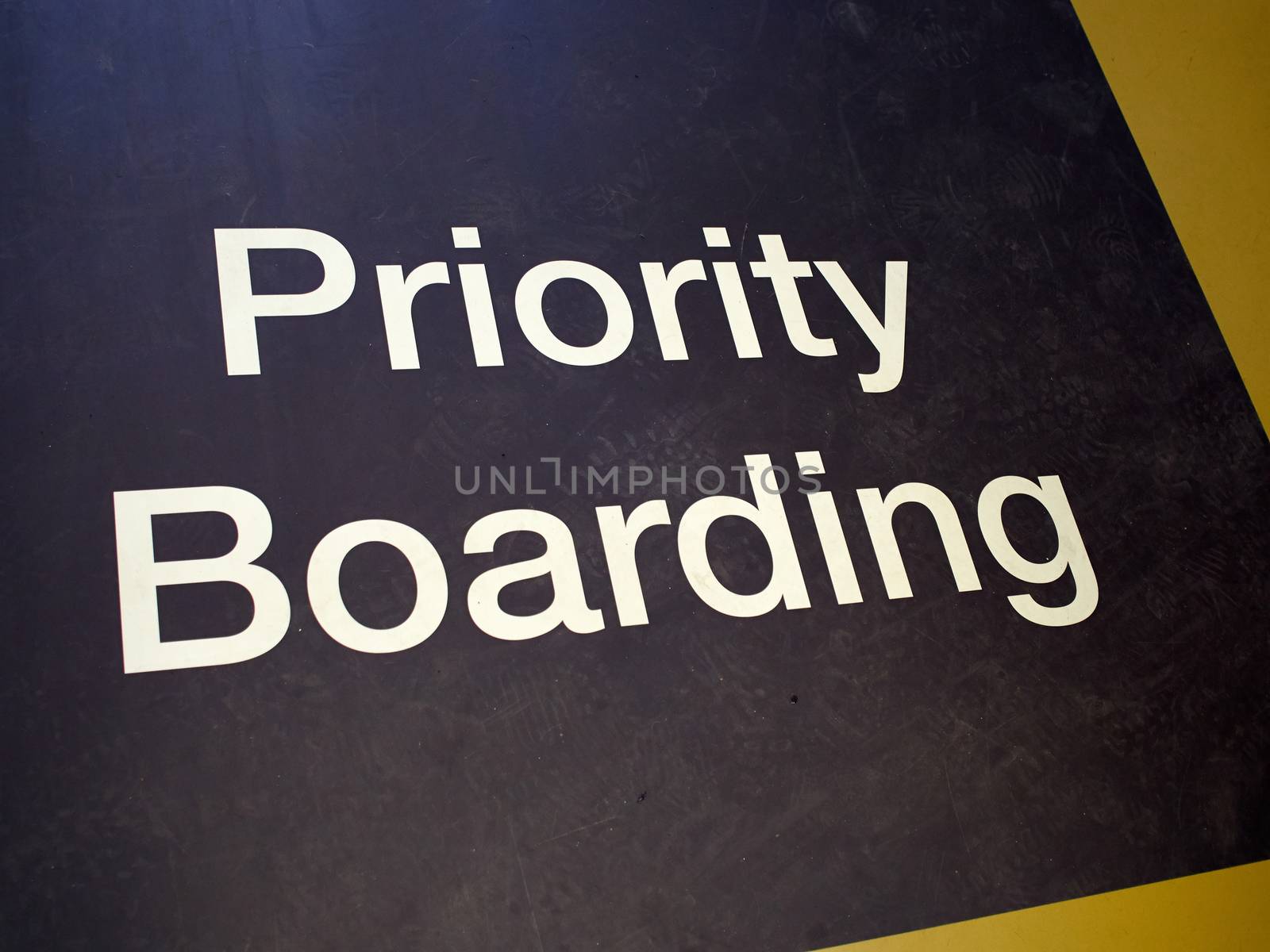 Priority boarding mat sign in departure passengers gate in an  international airport
