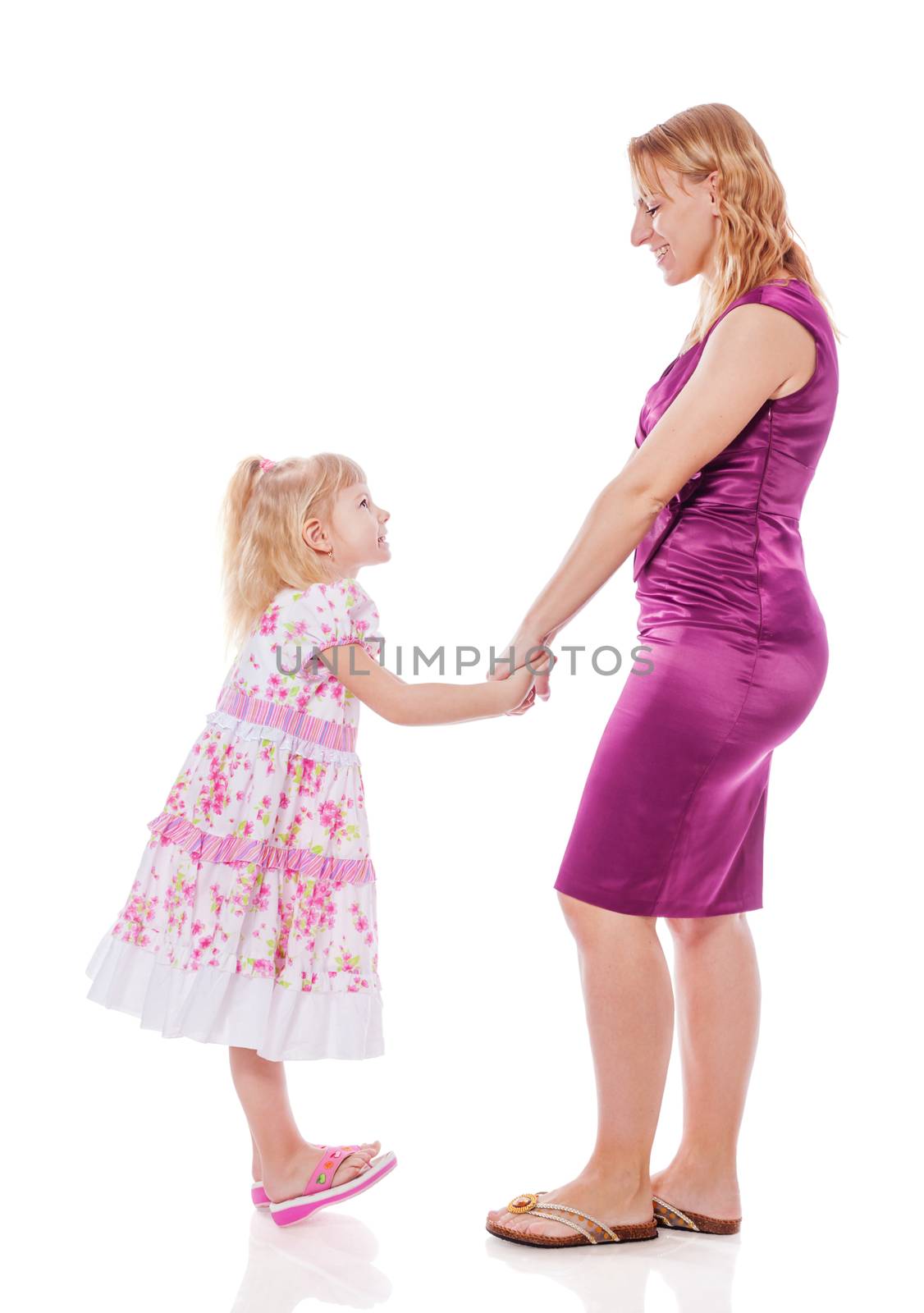 Mother and daughter standing holding hands isolated