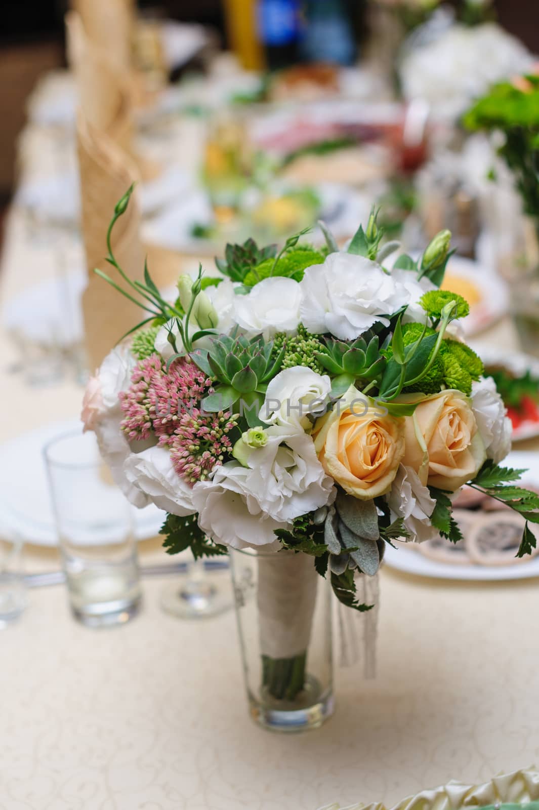 beautiful wedding bouquet on wedding table in restaurant.