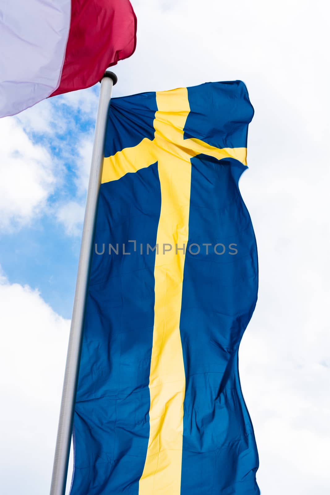 Swedish country flag arranged against a blue sky.