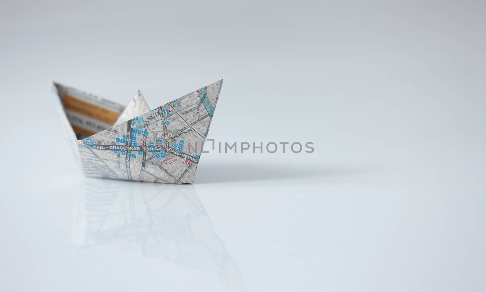 Paper ships from the map on a white