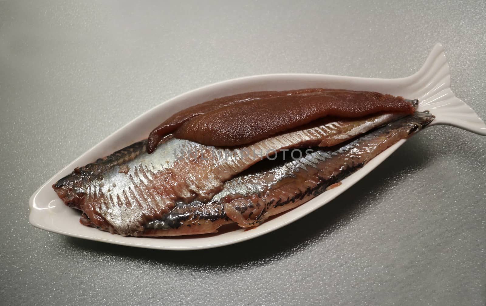 Salted herring fillet on the plate  by mrivserg