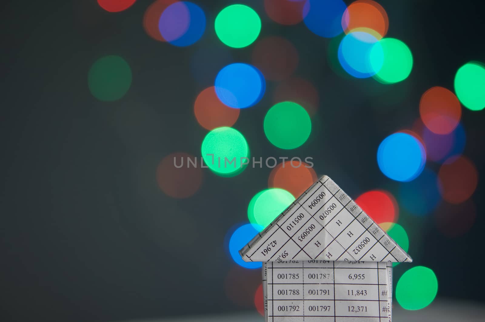 House has colorful bokeh circle or defocused of glitter at night as background.