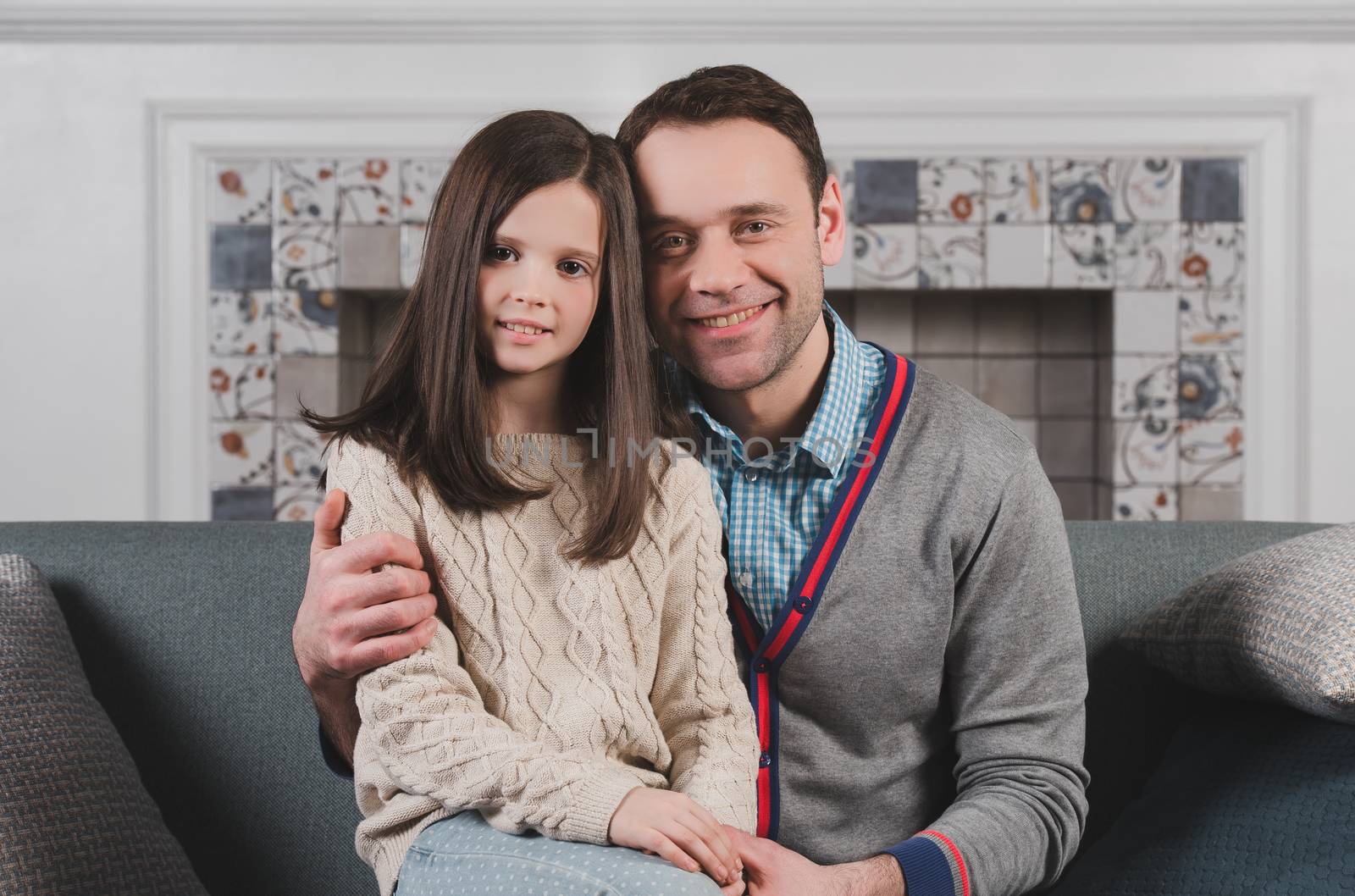 Family portrait of happy father and his daughter at home