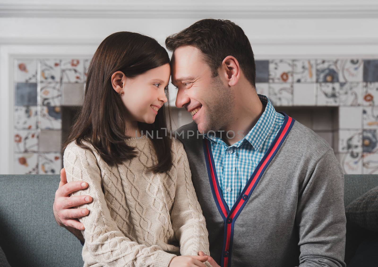 Family portrait of happy father and his daughter at home