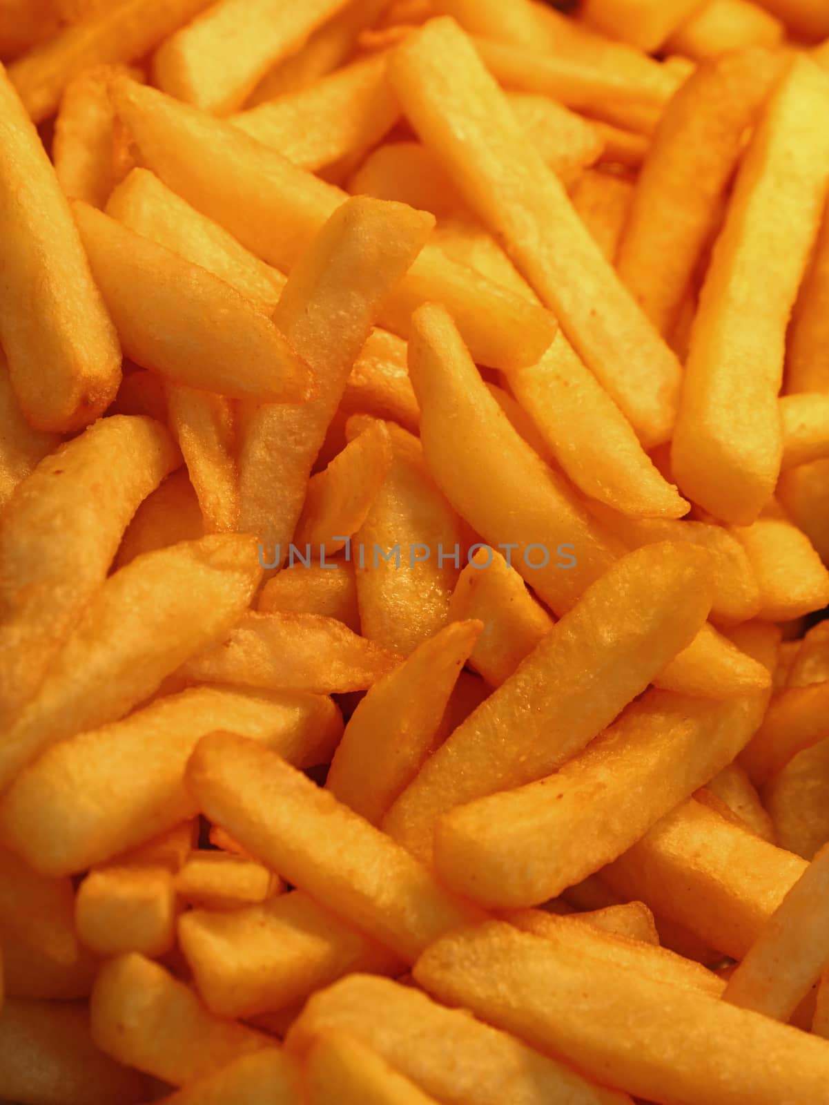 French fries, unhealthy deep fried potato chips close up, high angle view